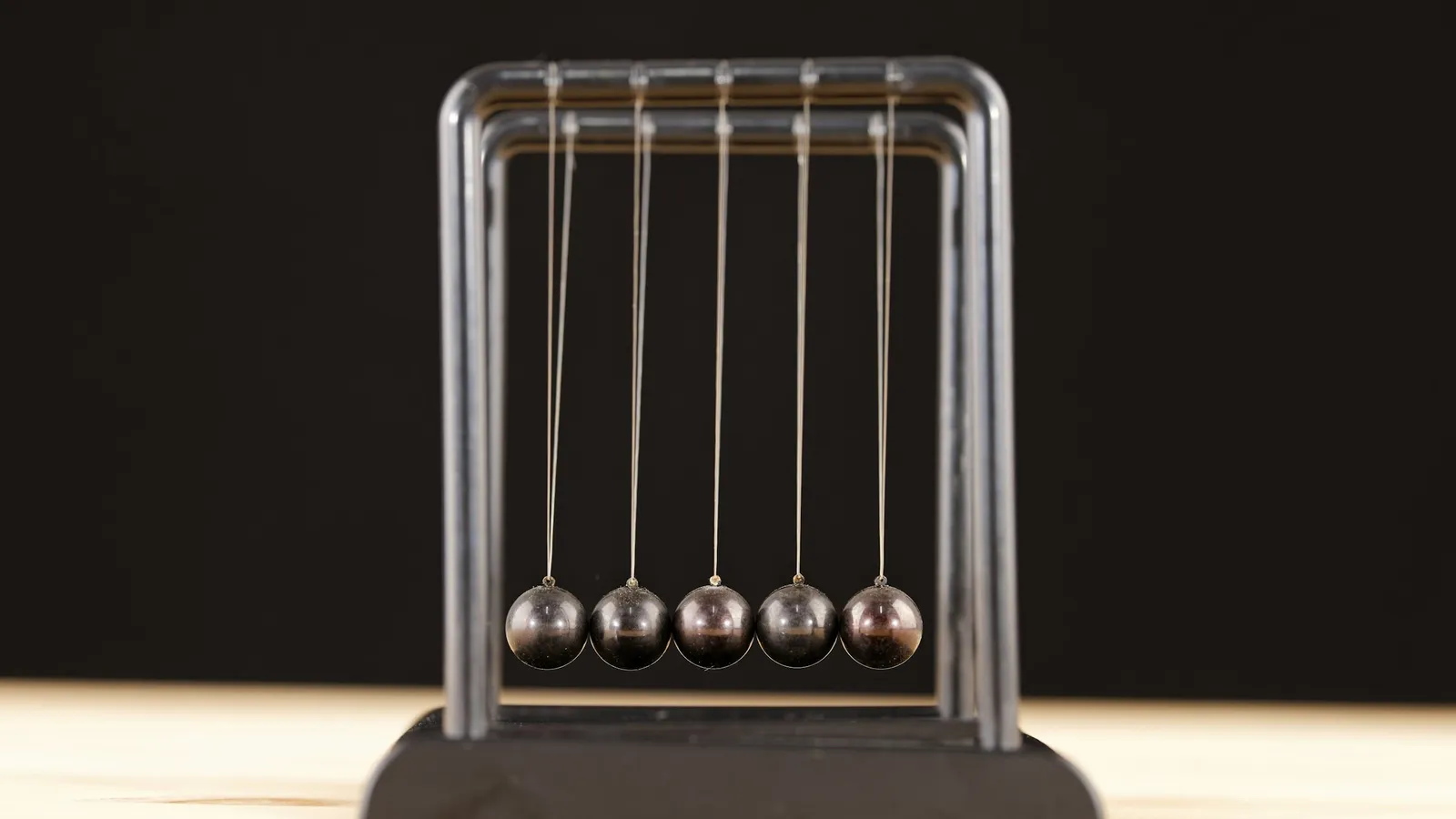 Newton's cradle on a dark background