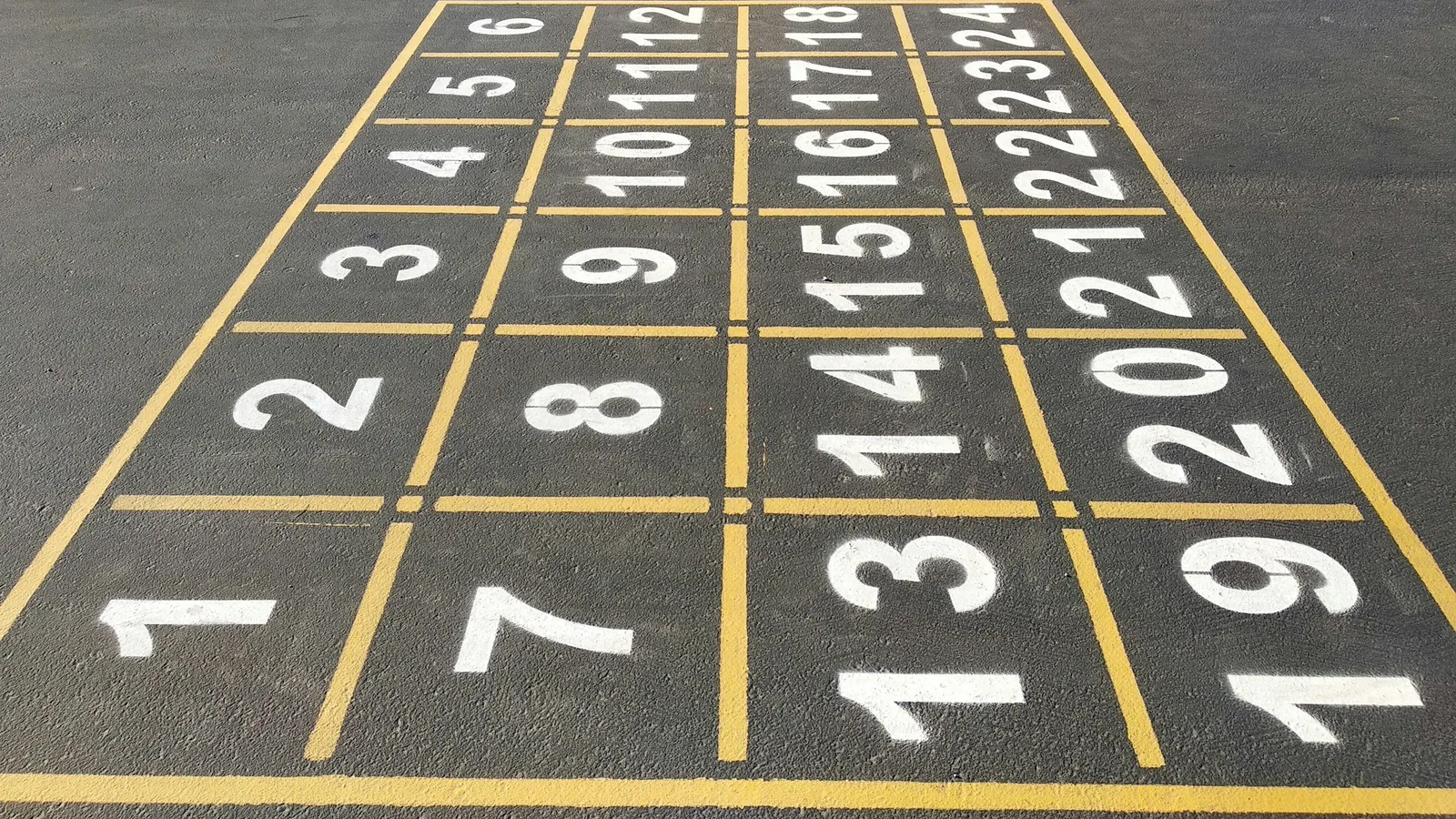 Numbered squares painted on a playground in rows