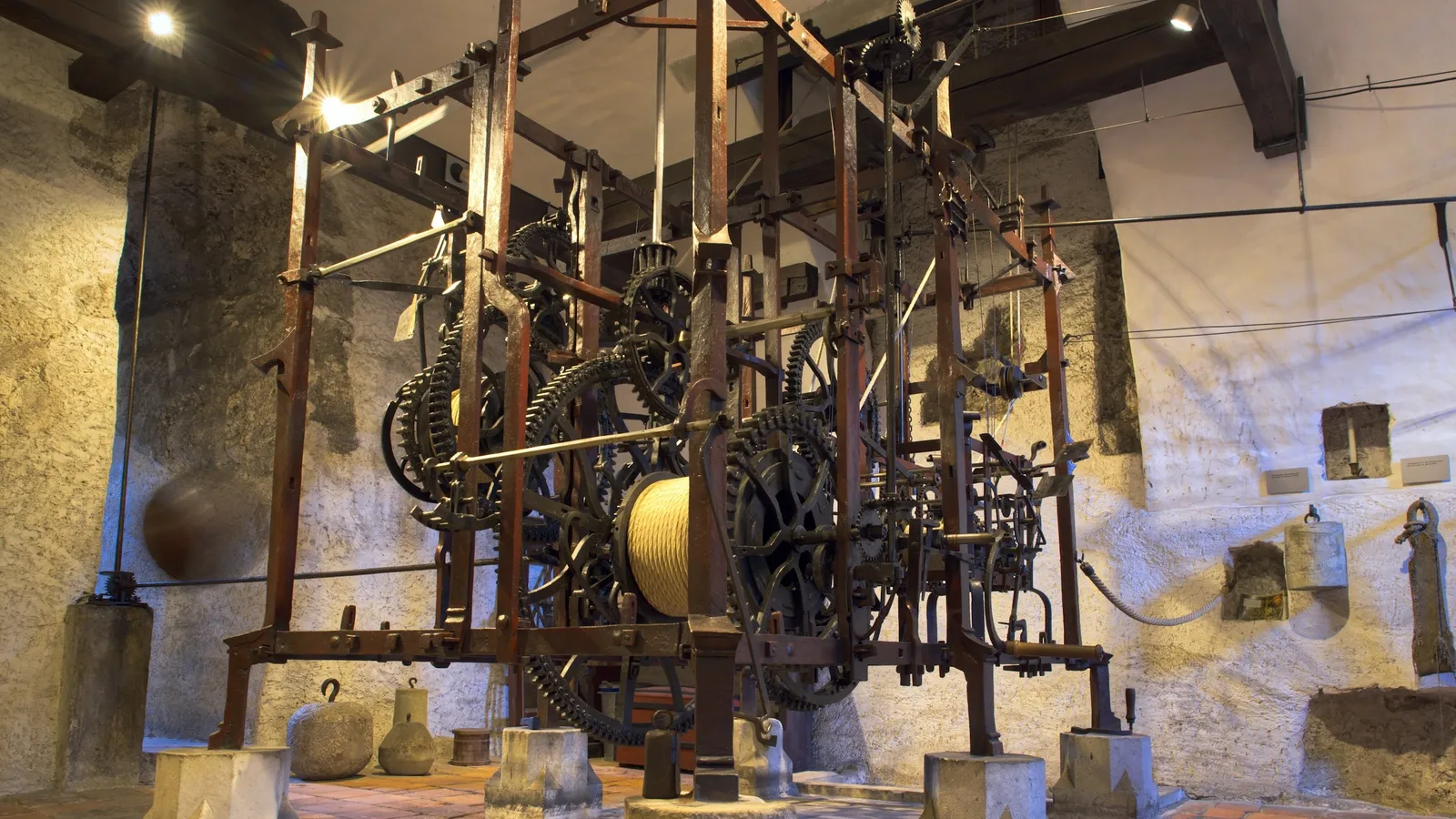 Old gears and machinery on display in a museum hall