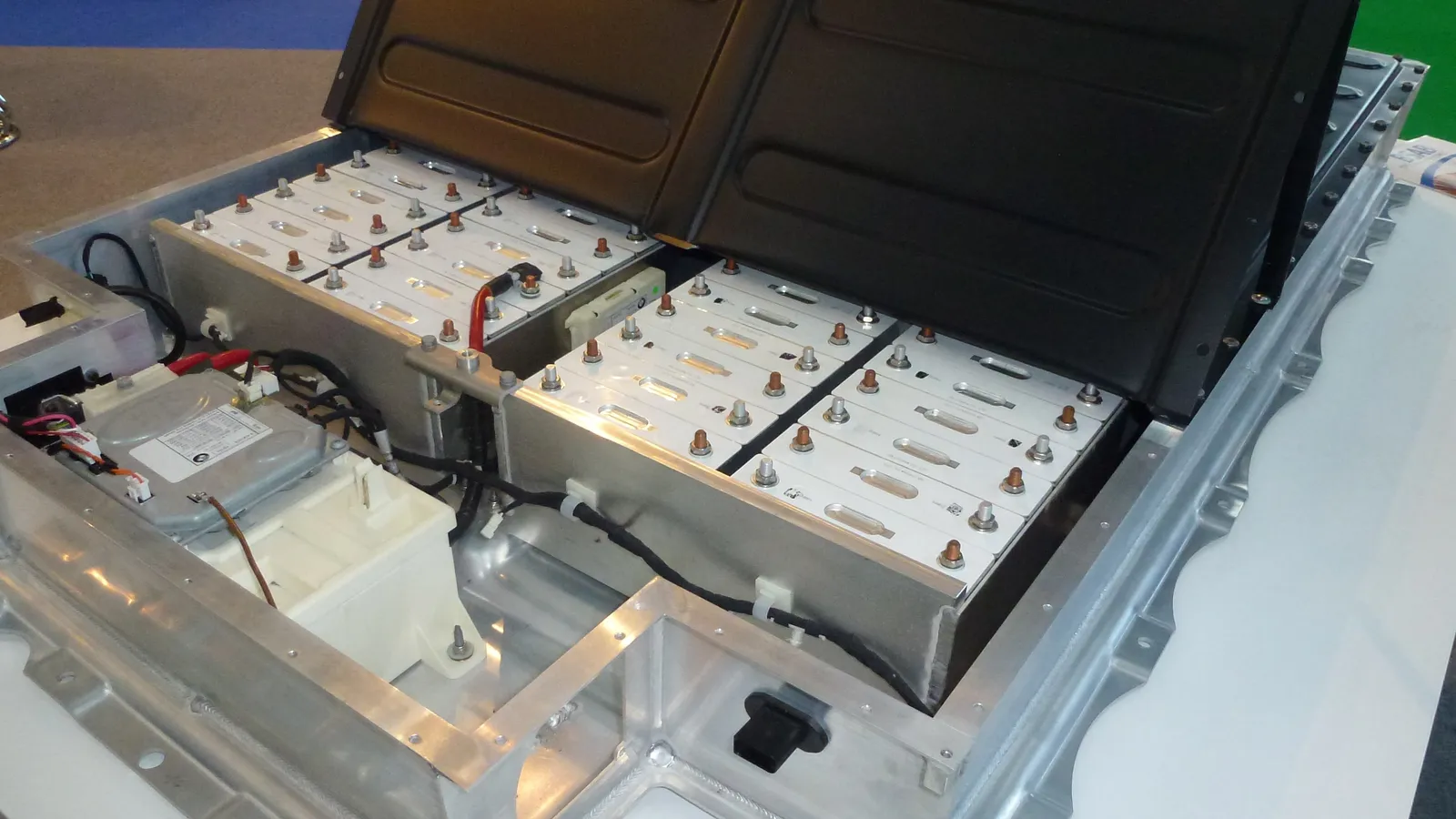 Open electric car battery pack with rows of cells in an aluminium tray