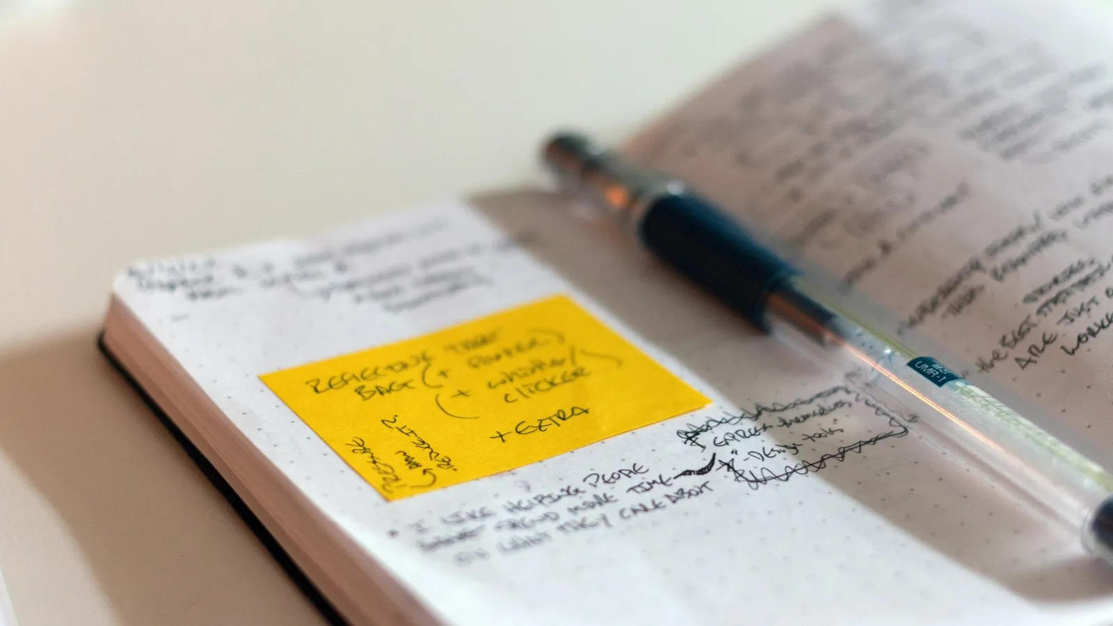 Open notebook with revision notes and a pen