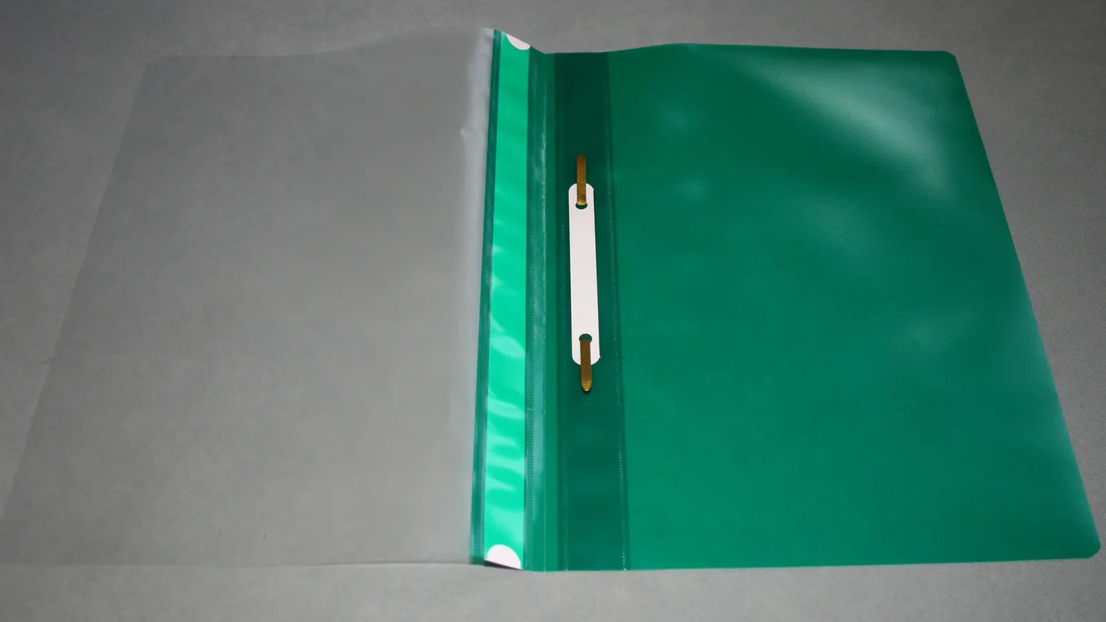 Open plastic file folder with a clear front cover, green back and metal fastener