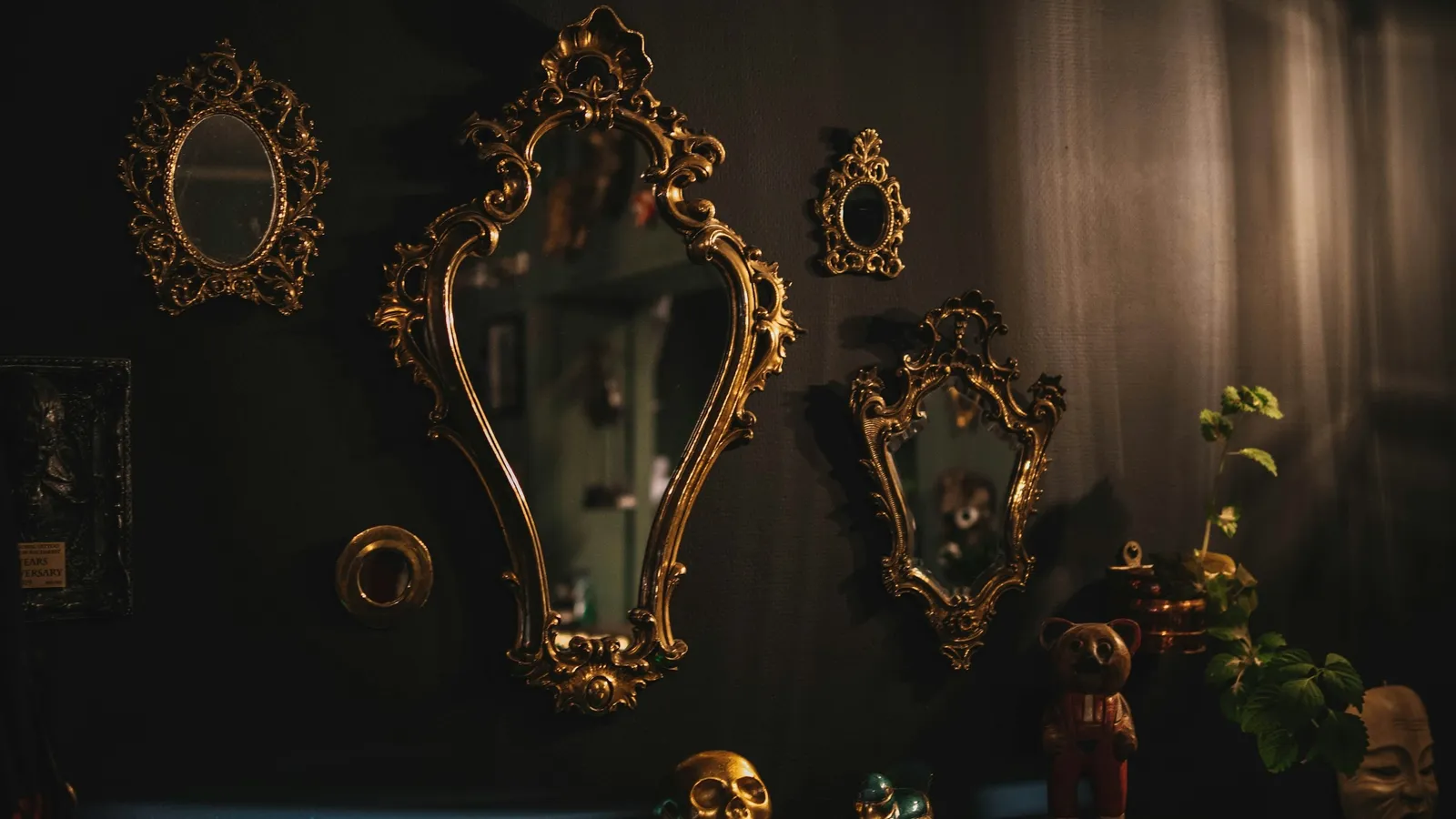 Ornate mirrors hanging on a dark wall