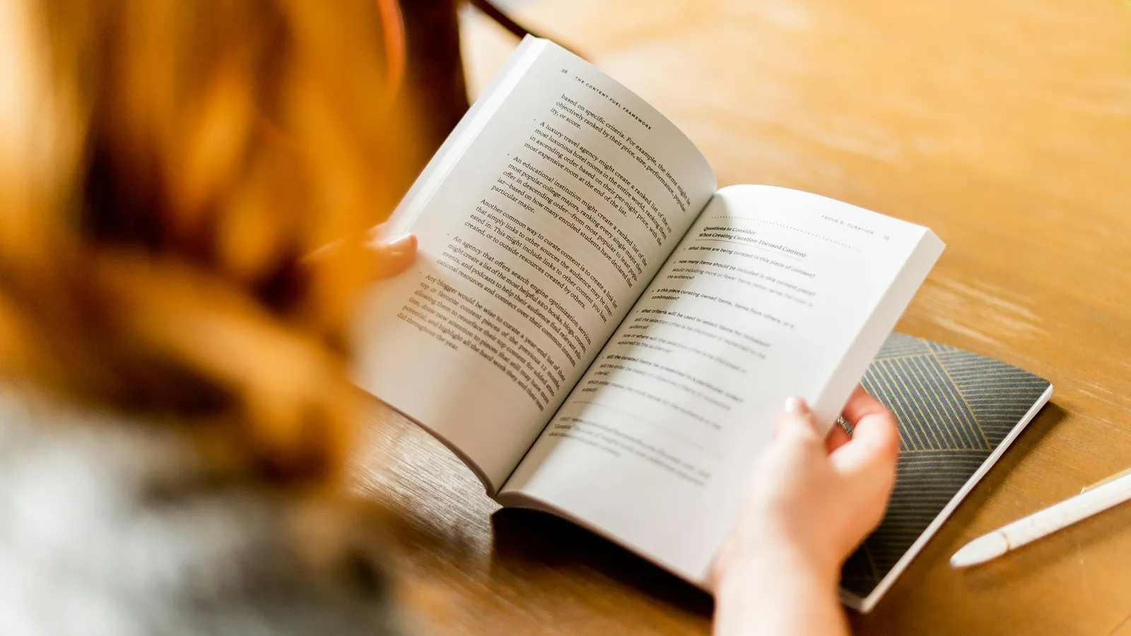 Person reading an open book