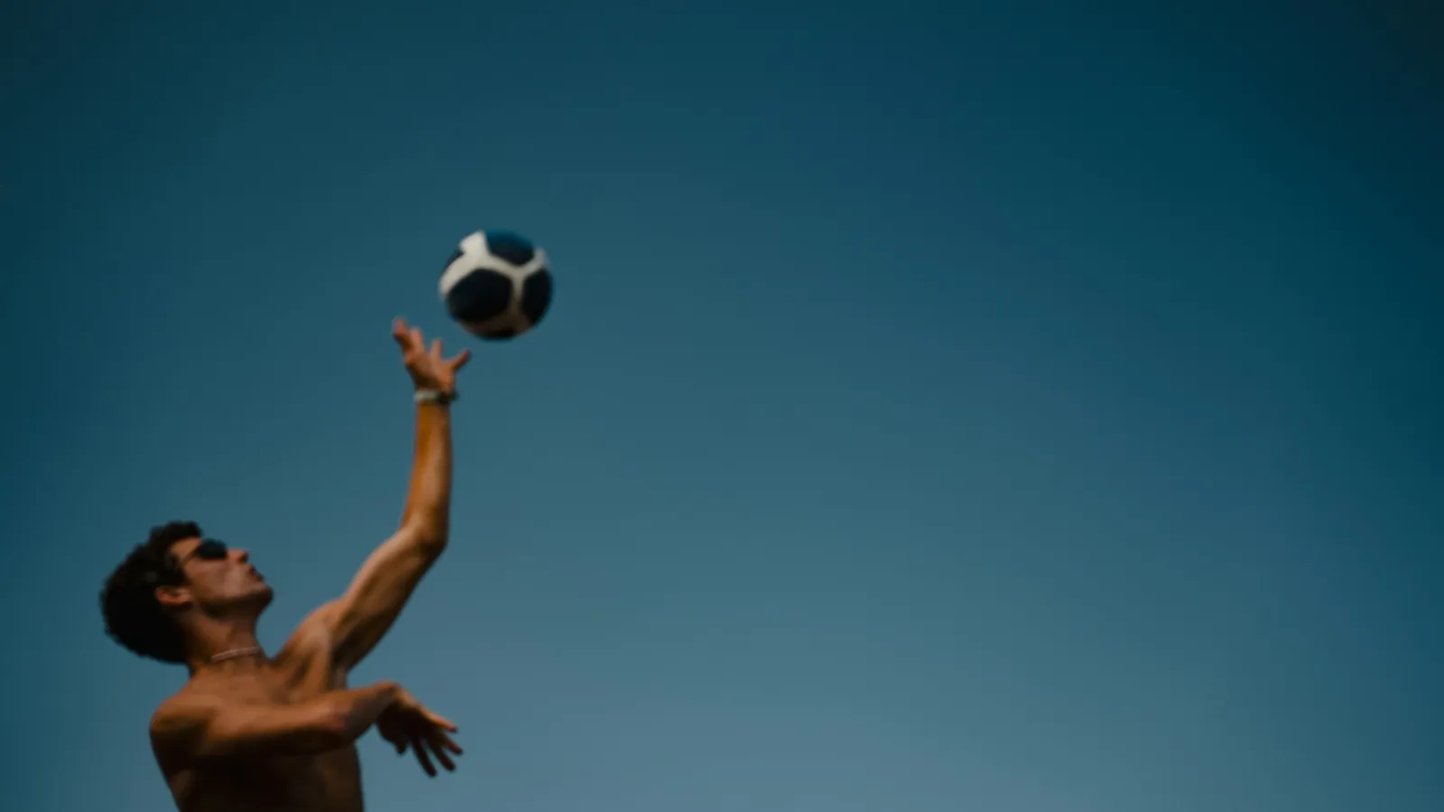 Person throwing a ball up into the air