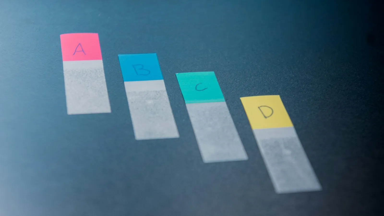 pH test strips showing different colours