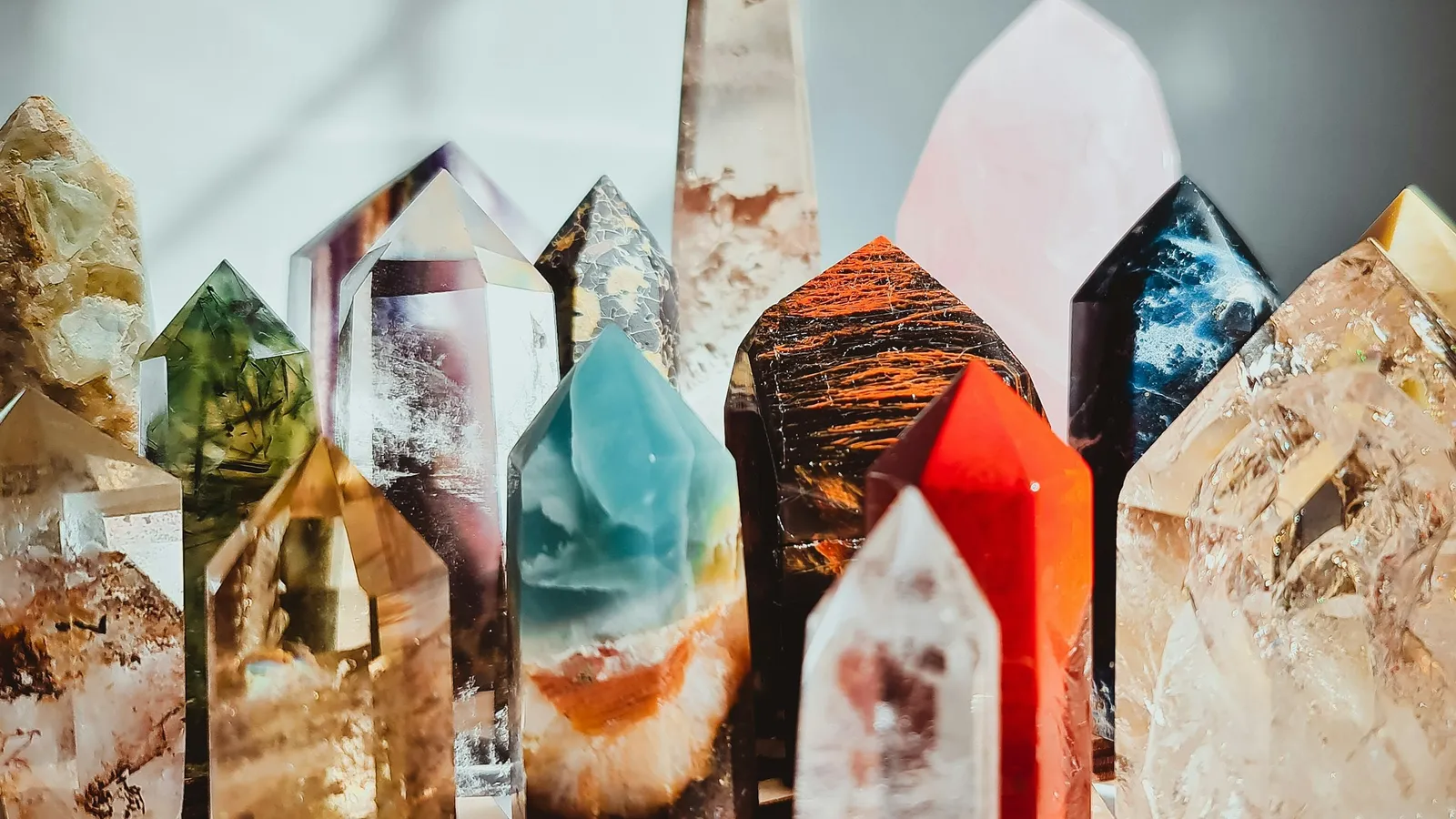 Pointed quartz crystals of different colours standing upright