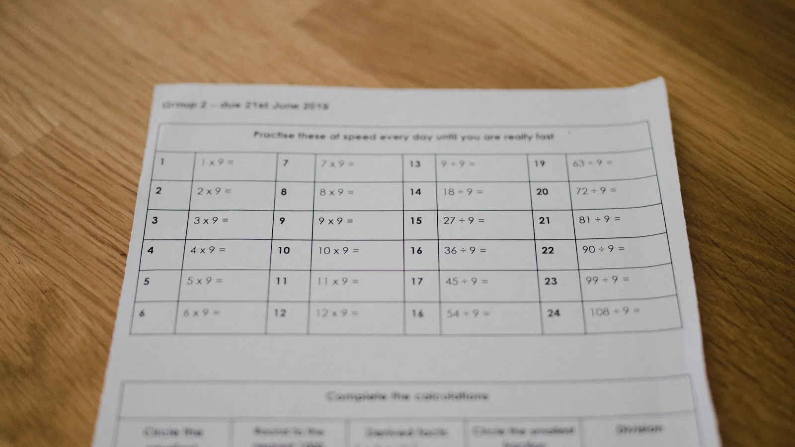 Printed test paper with a table of answers on a wooden desk
