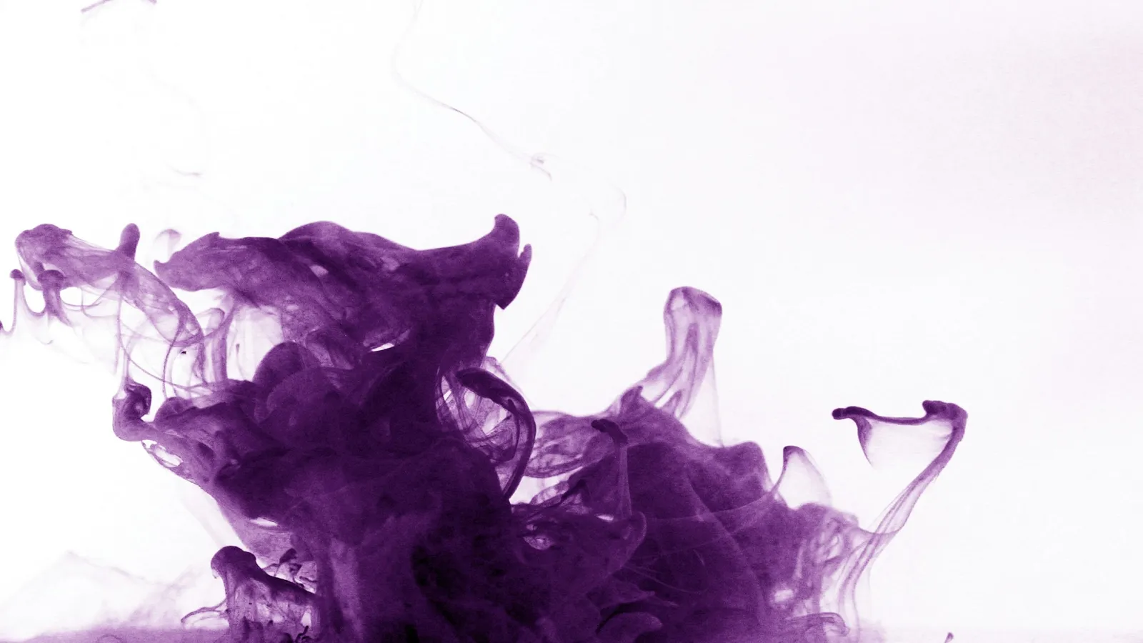 Purple dye spreading through clear water
