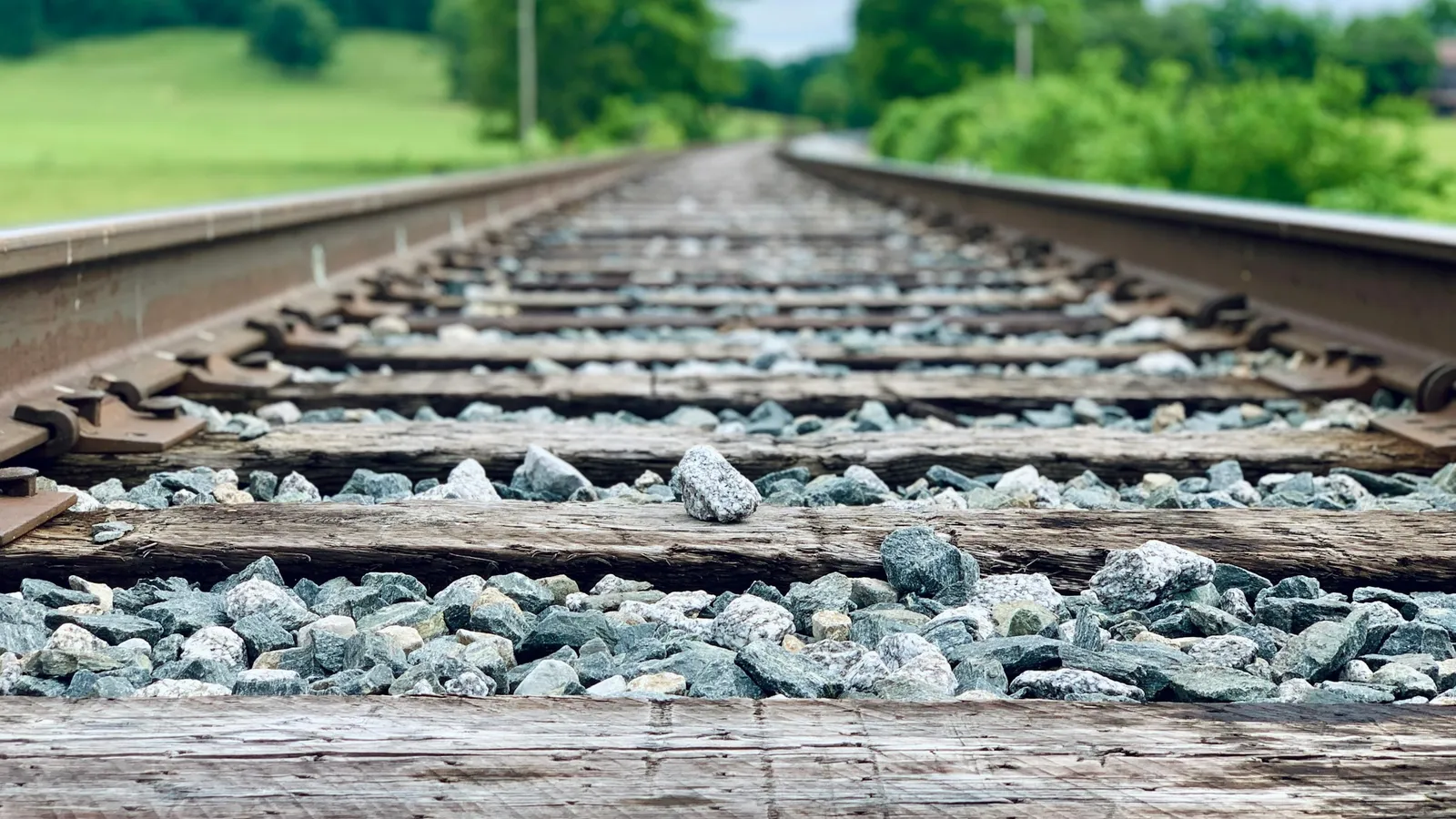 Railway tracks on gravel stretching into the distance