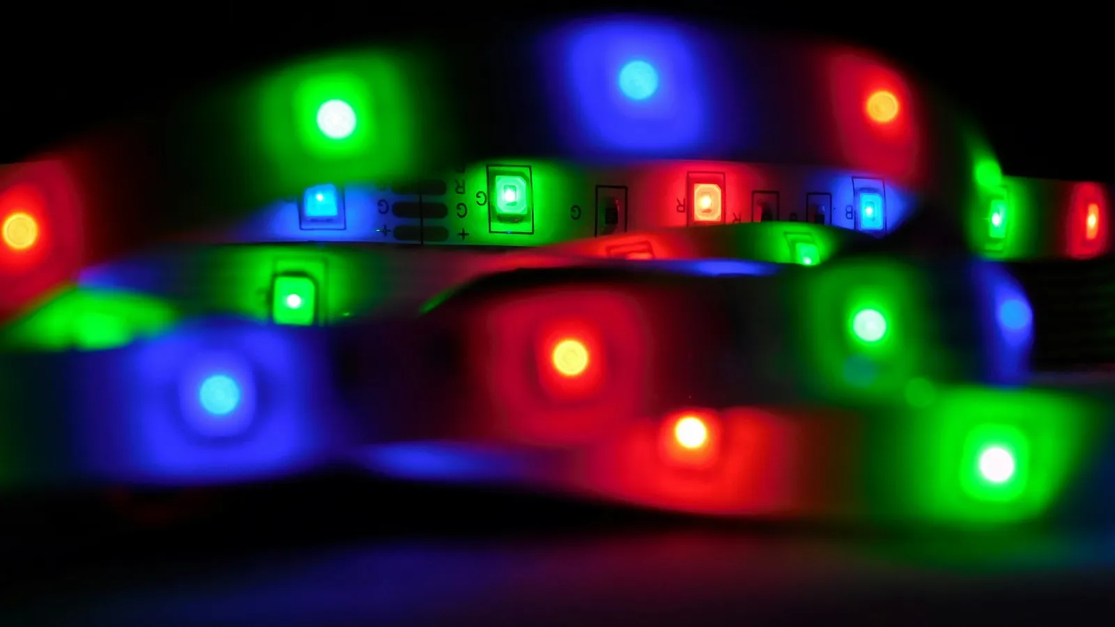Red, green and blue LEDs glowing on a strip in the dark