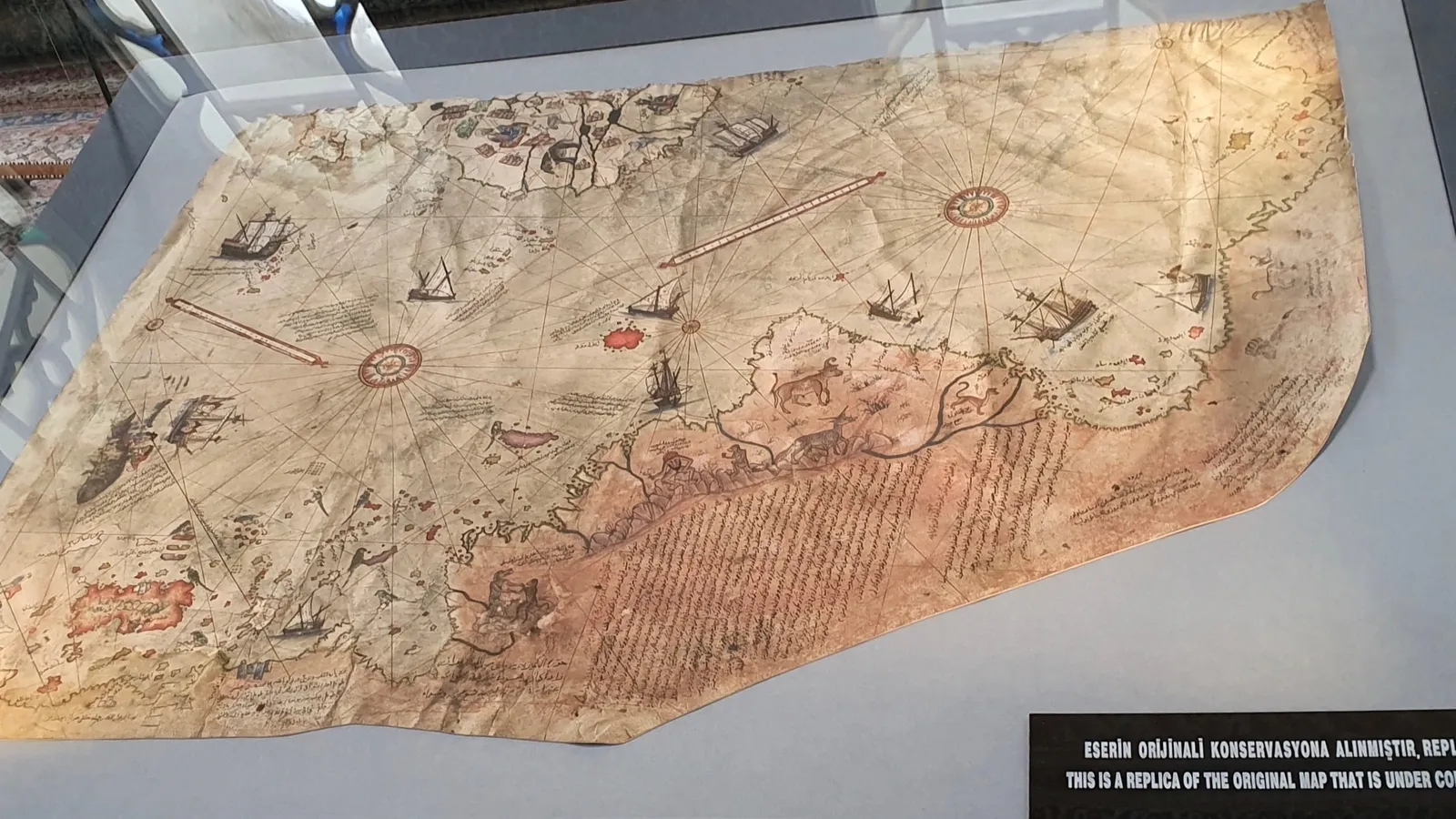 Replica of the 1513 Piri Reis parchment map in a museum display case