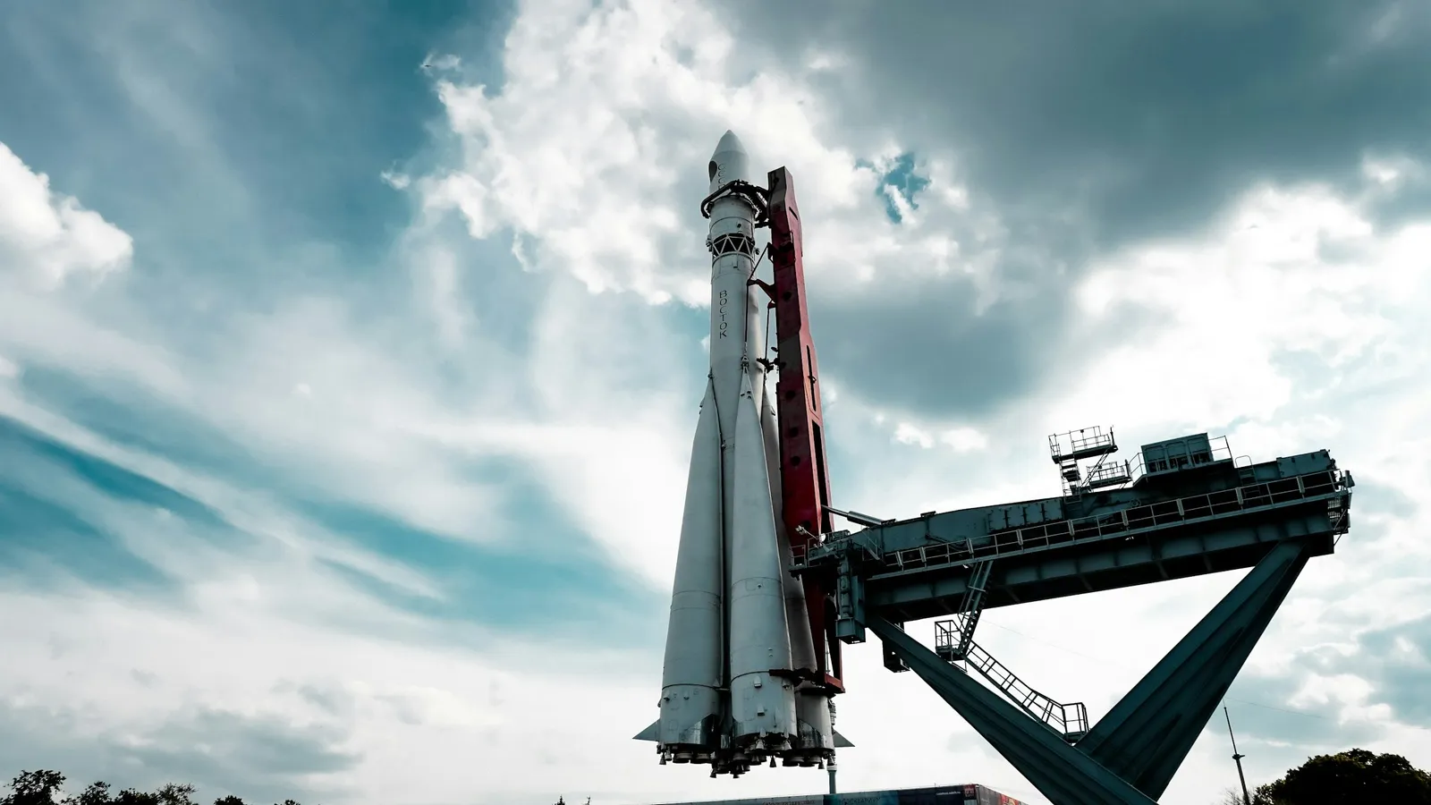 Rocket standing on a launch pad under a cloudy sky