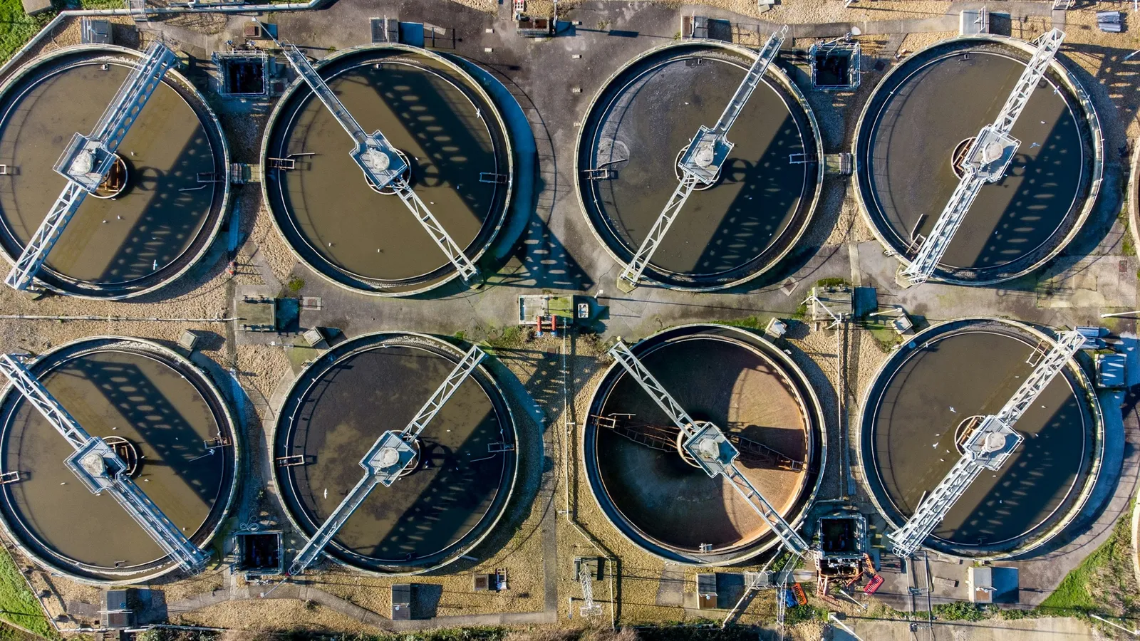 Round settling tanks at a sewage plant seen from above