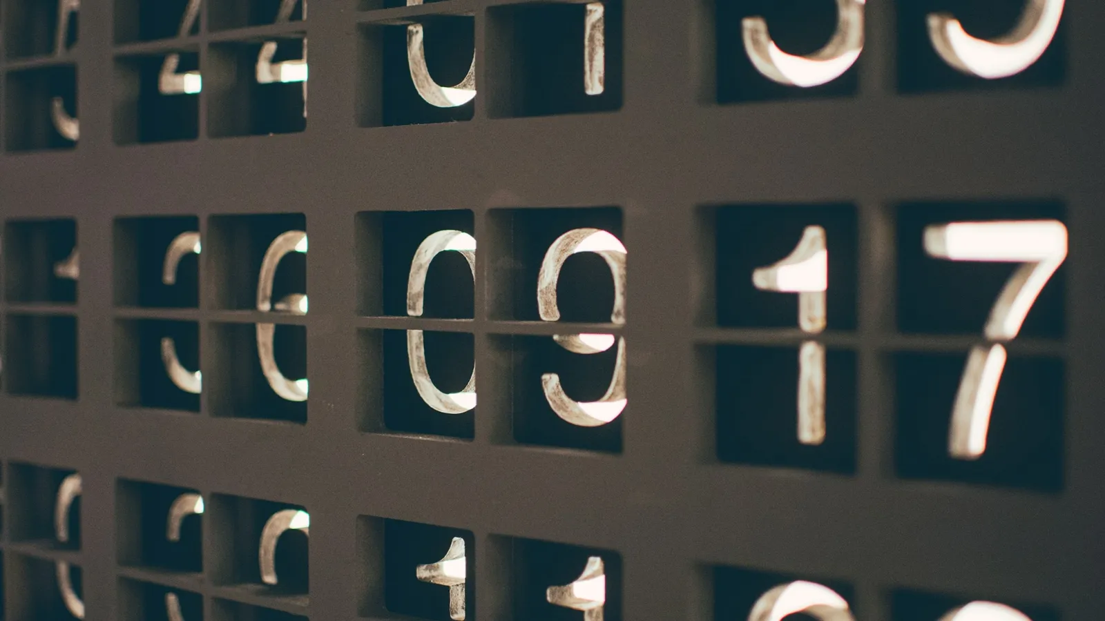 Rows of large white numbers on dark tiles