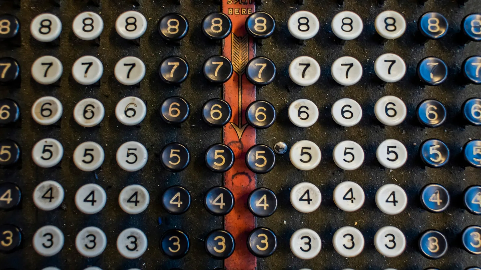 Rows of numbered round keys on an old machine