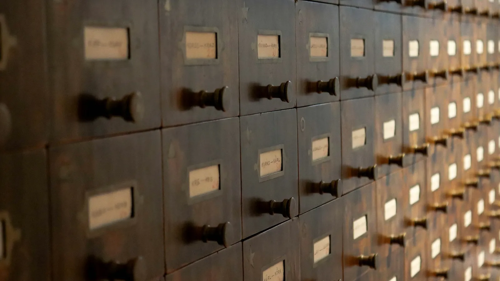 Rows of small wooden library card drawers