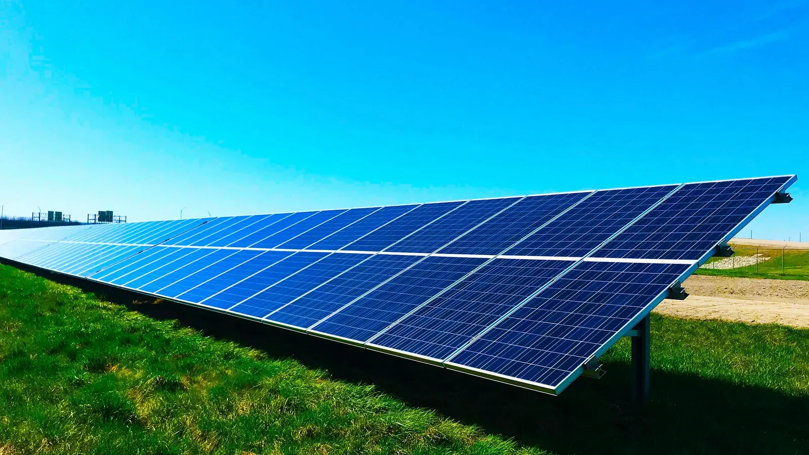 Rows of solar panels under a blue sky