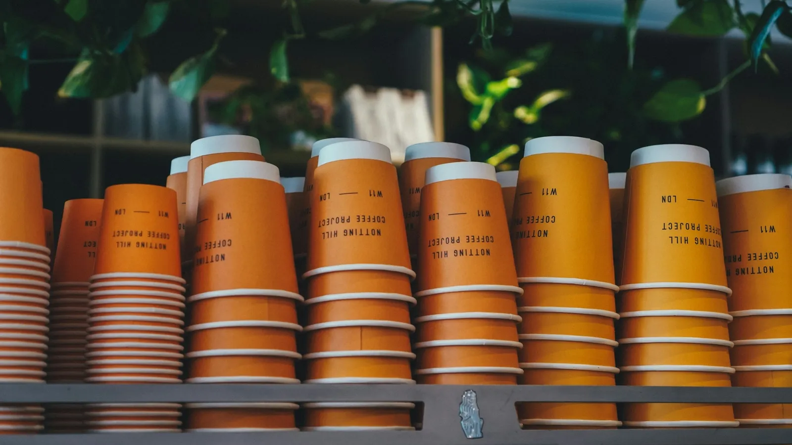 Rows of stacked orange paper cups