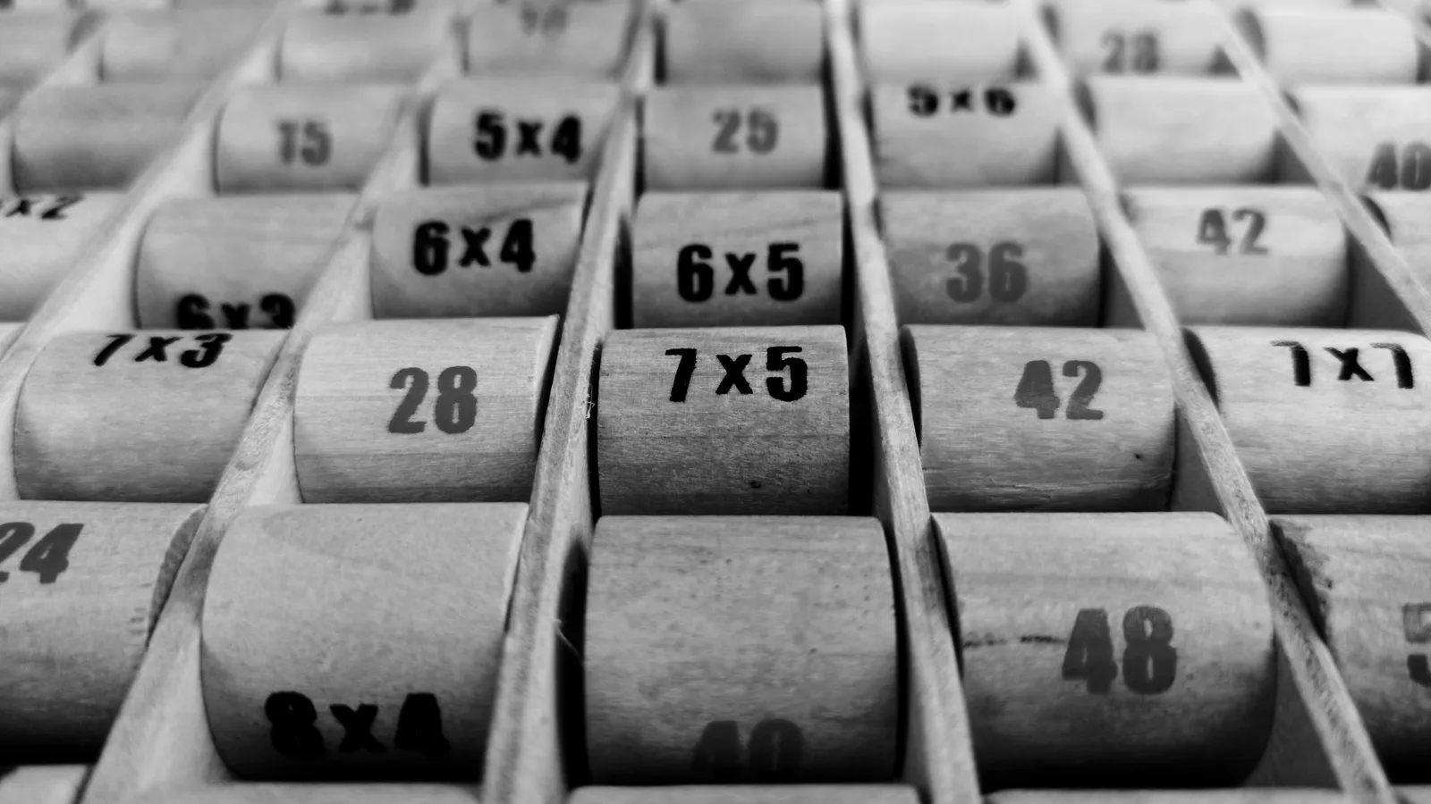 Rows of wooden number tiles in a tray