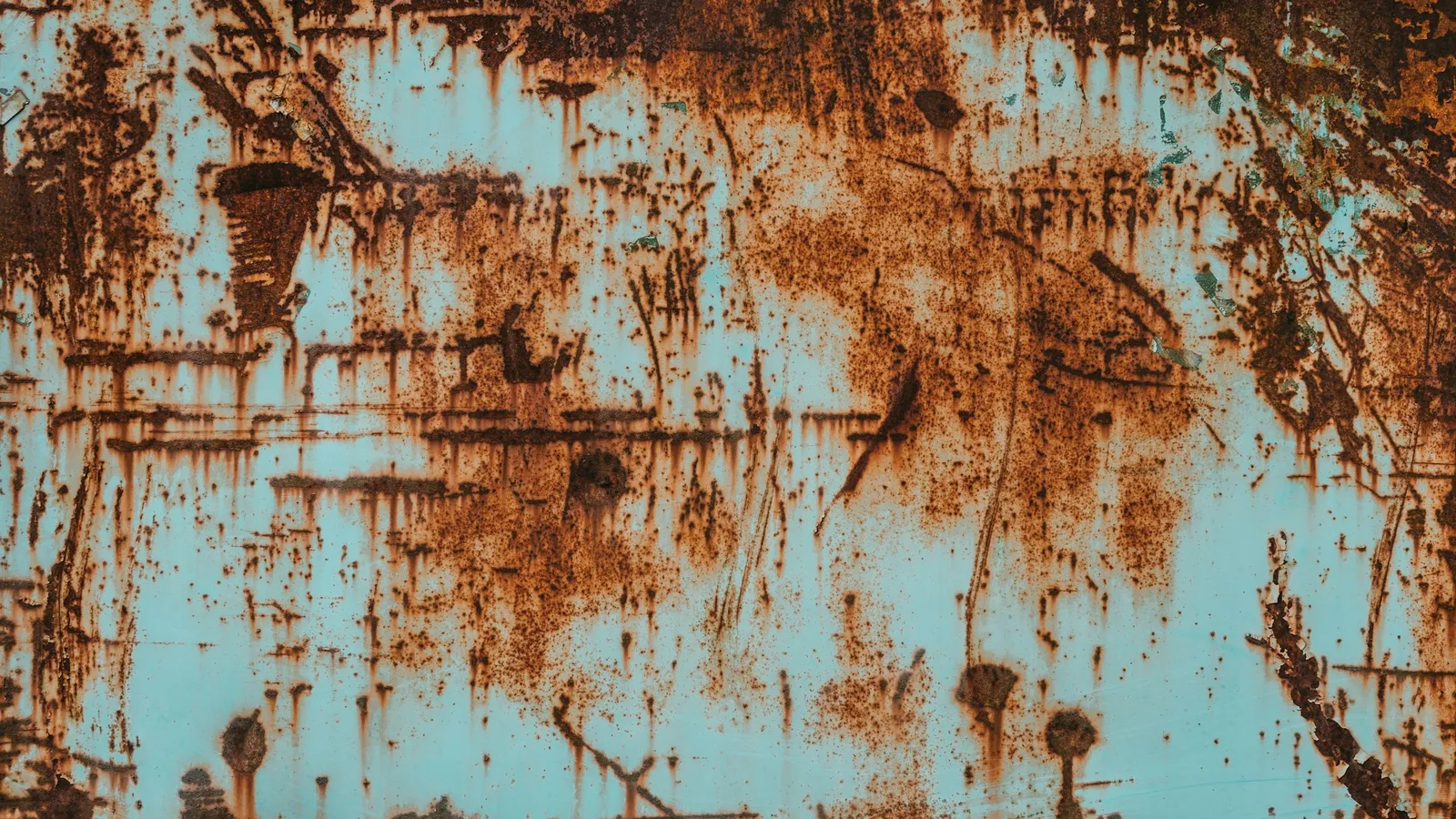 Rust spreading across a painted metal surface