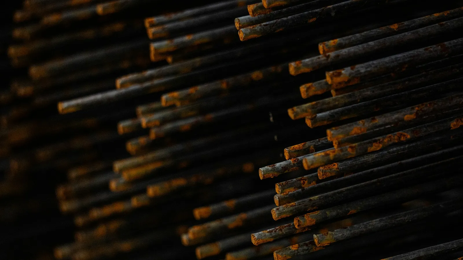 Rusty iron bars stacked closely together