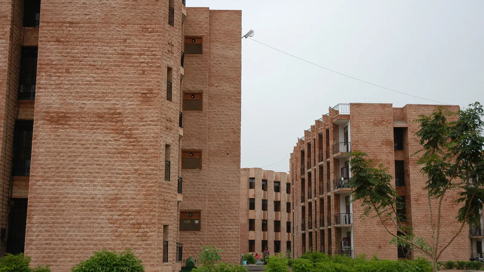 Sandstone student hostel blocks with balconies at National Law University, Jodhpur