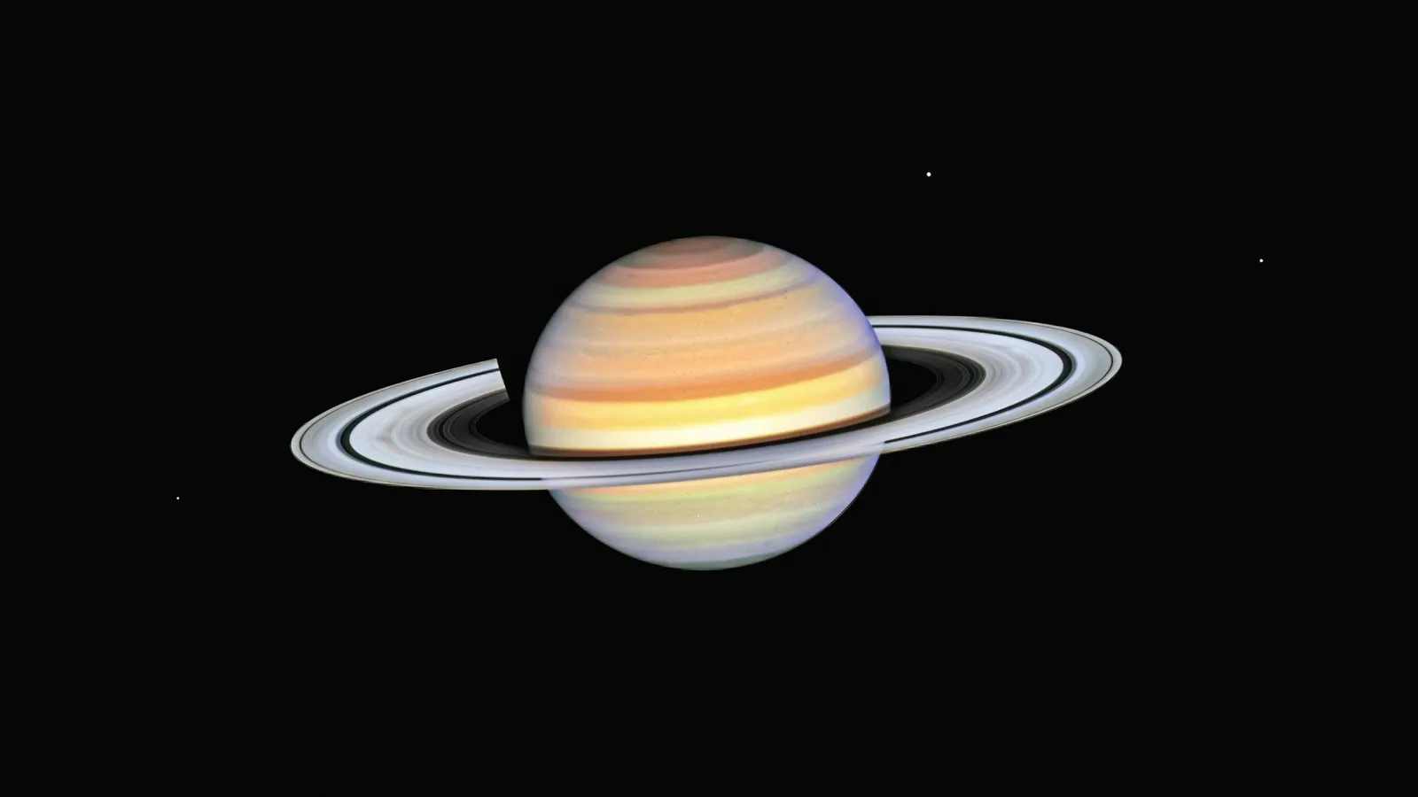 Saturn with its wide rings against black