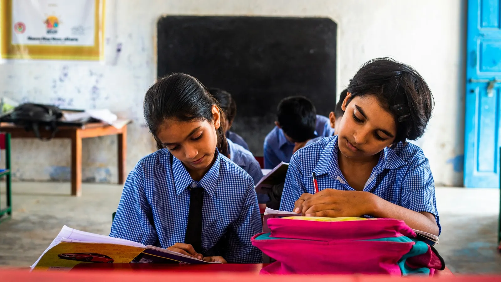 Schoolgirls in uniform studying in a classroom
