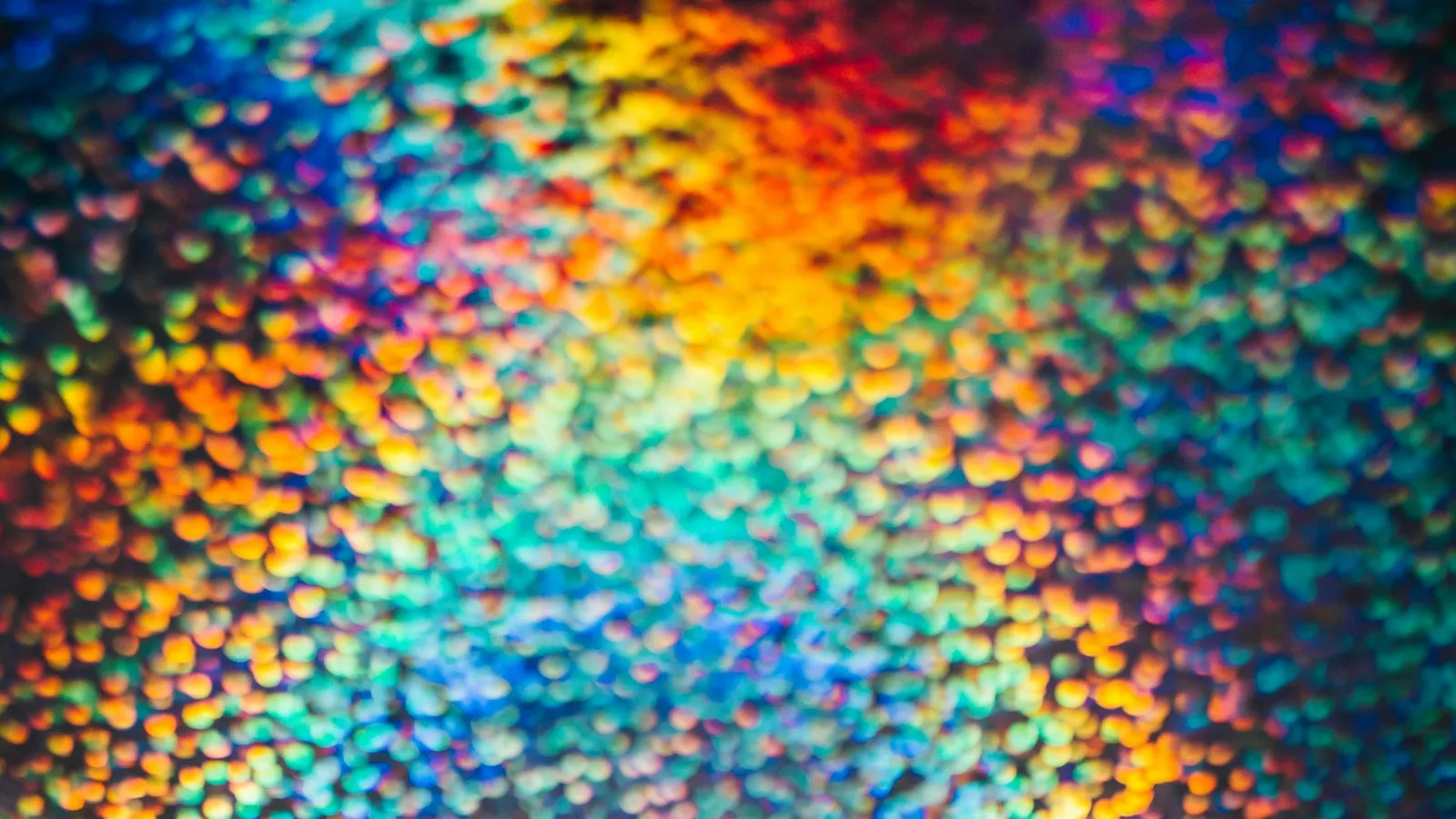 Shimmering rainbow colours like a liquid crystal film