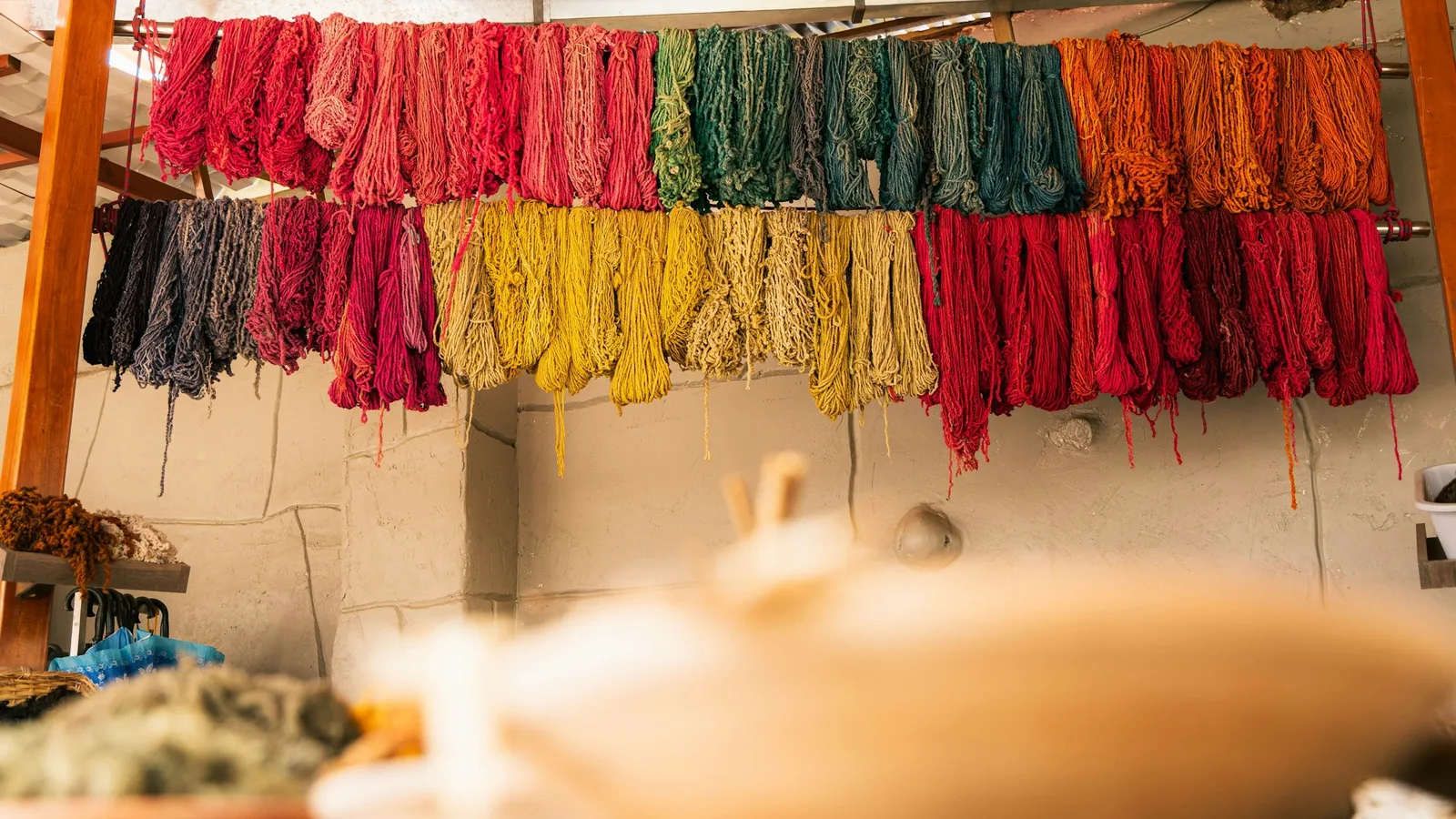 Skeins of dyed yarn in many colours hanging up