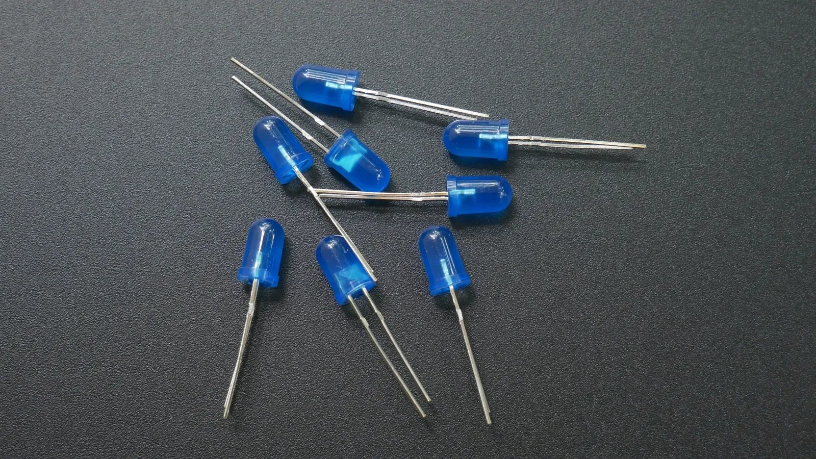 Small blue electronic components on a grey surface