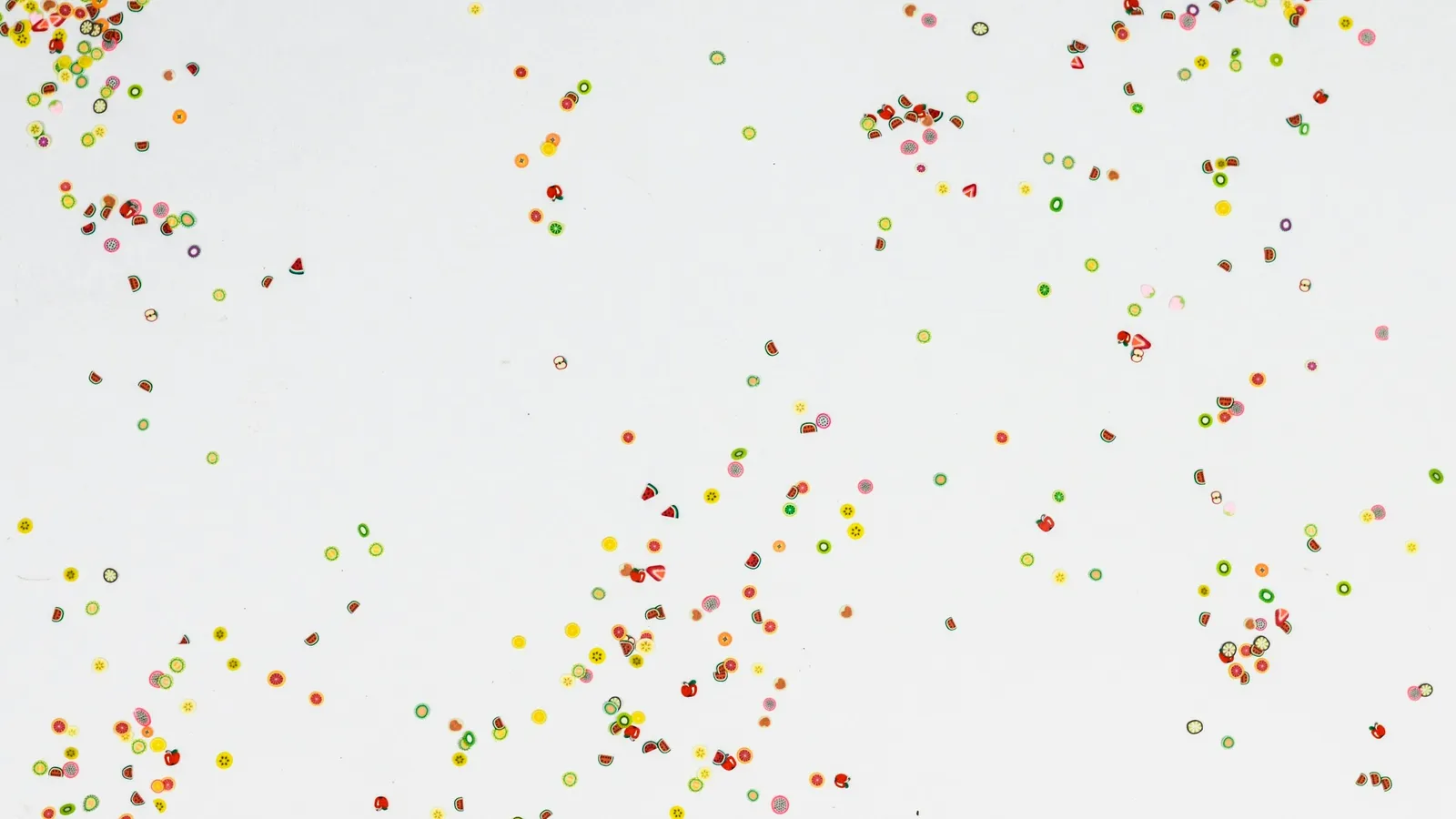 Small coloured dots scattered across a white background