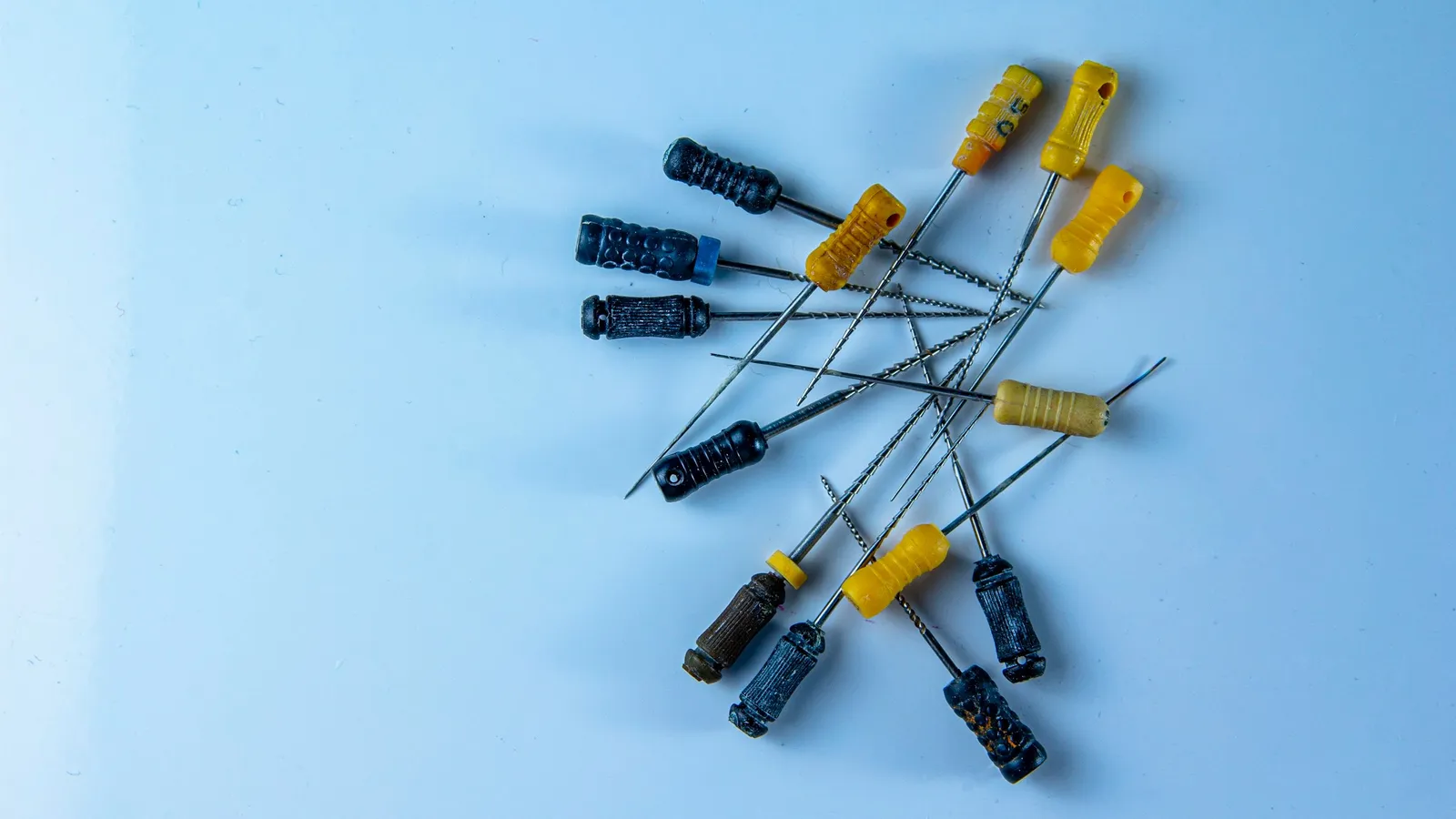 Small electrolytic capacitors scattered on a blue surface