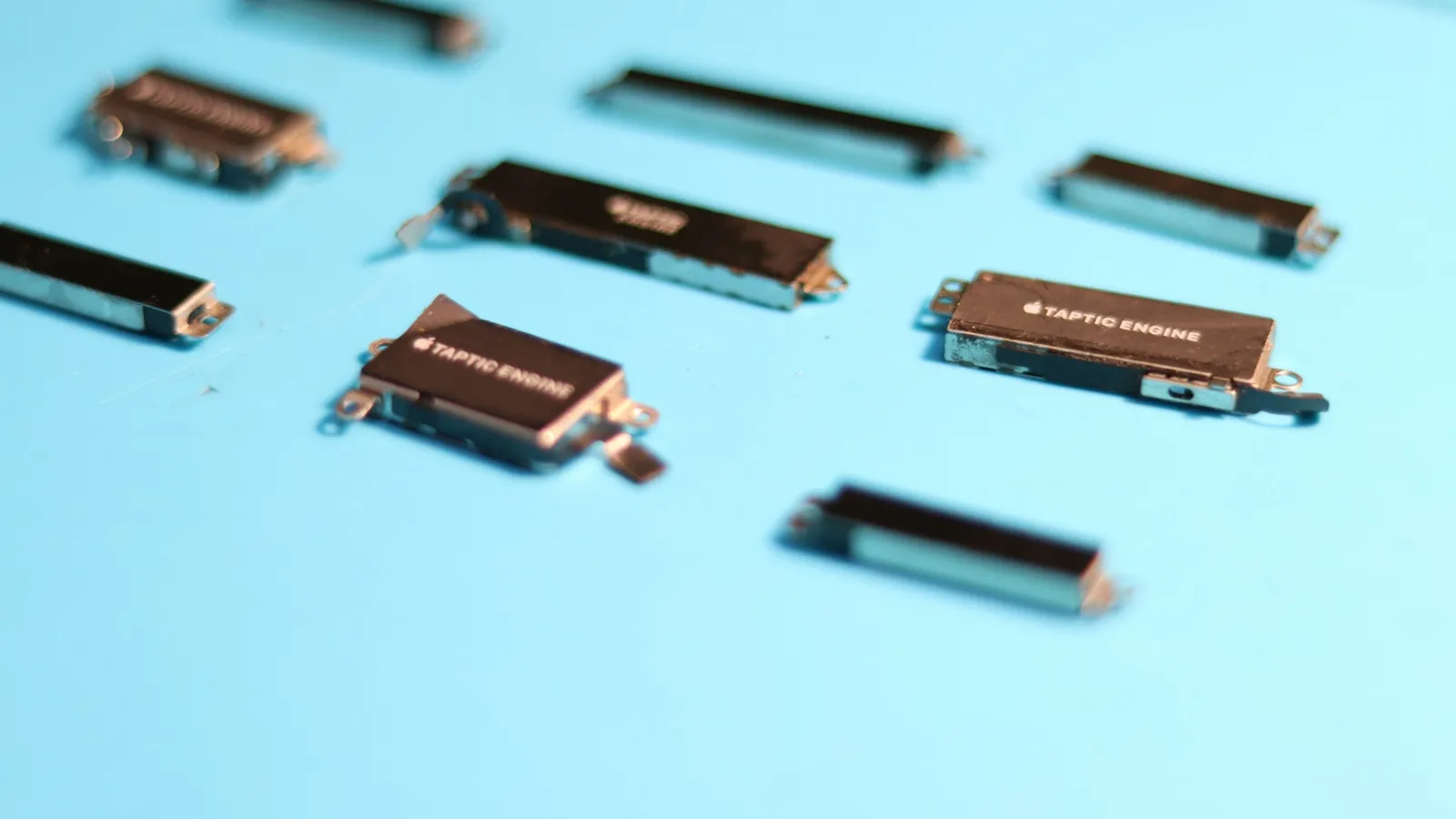 Small electronic components laid out on a light blue surface