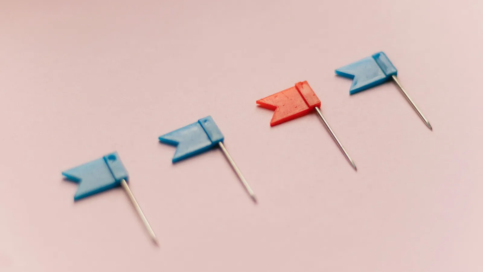 Small flag pins lined up in a row