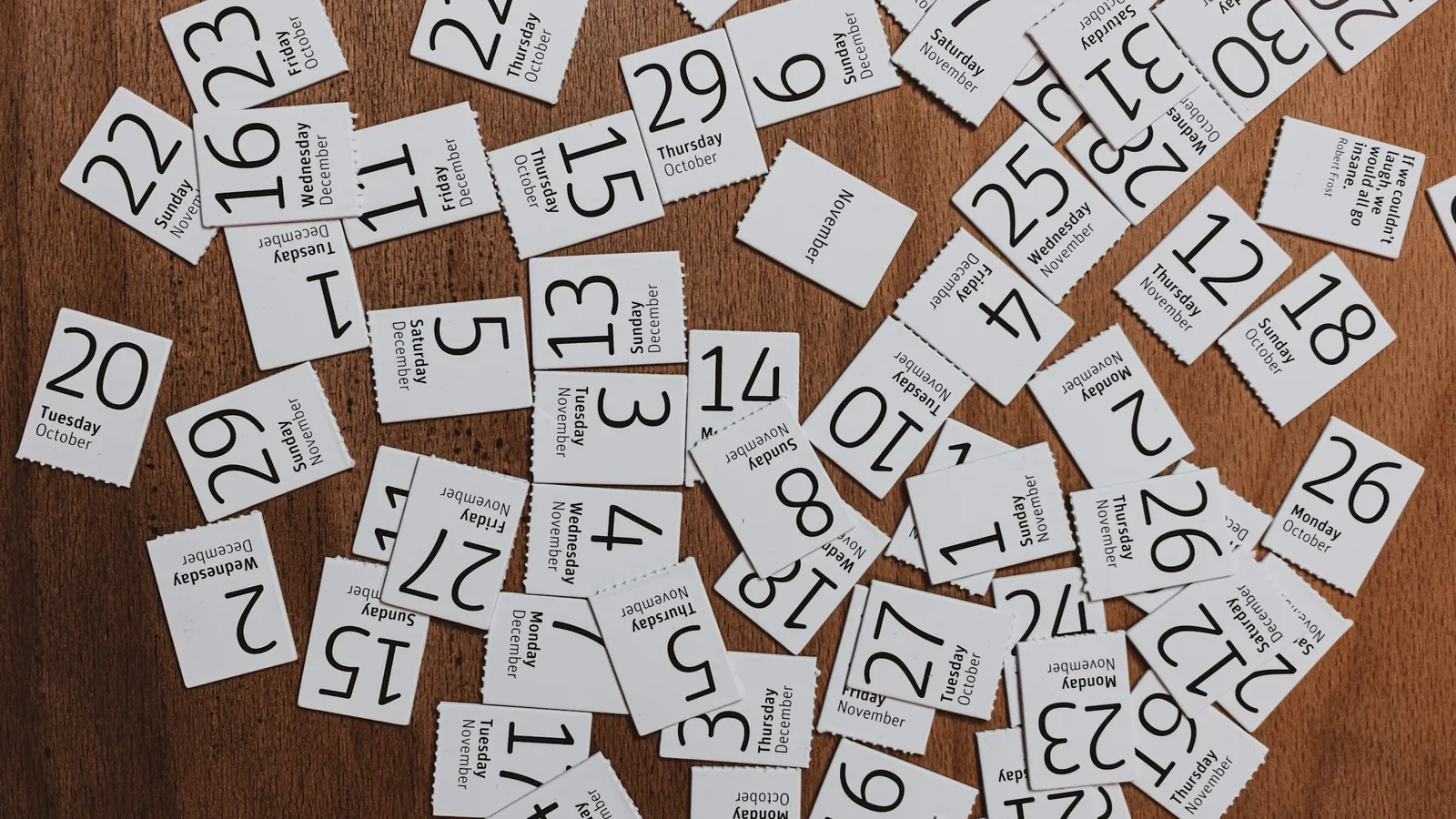 Small paper slips printed with numbers scattered on wood