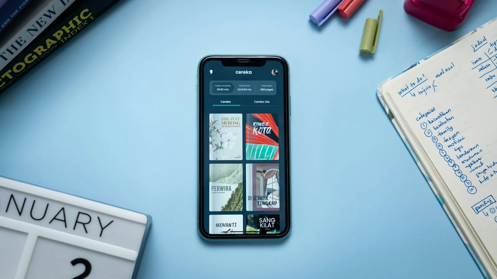 Smartphone on a desk next to a calendar