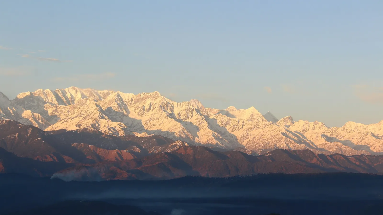 Snow-capped Himalayan peaks glowing at sunrise