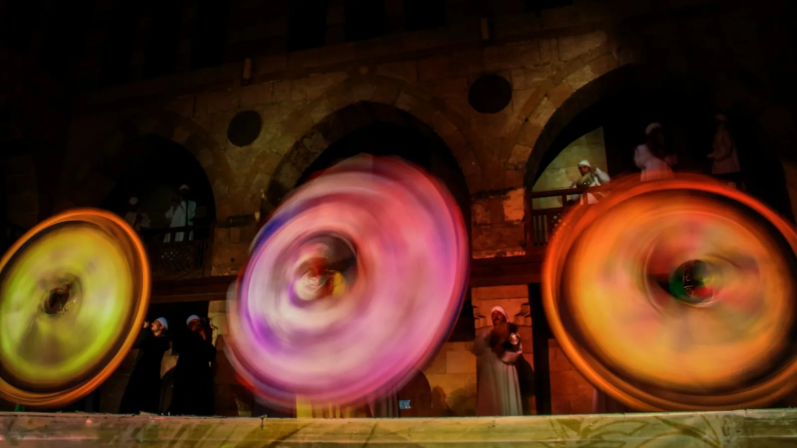 Spinning wheels of coloured light blurred by motion
