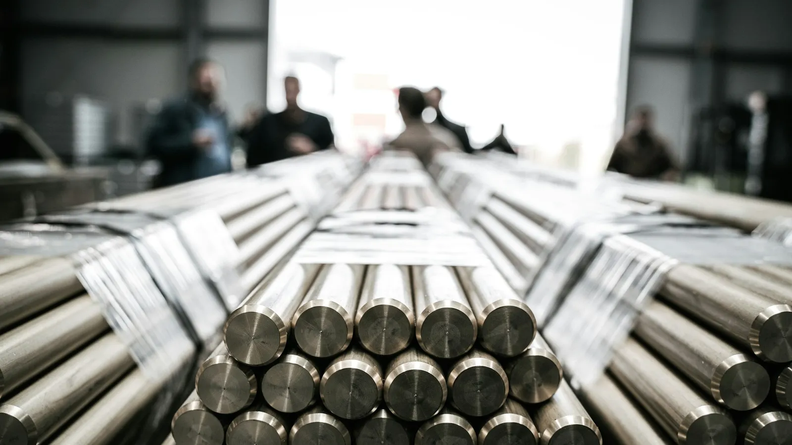 Stacked bars of steel in a workshop