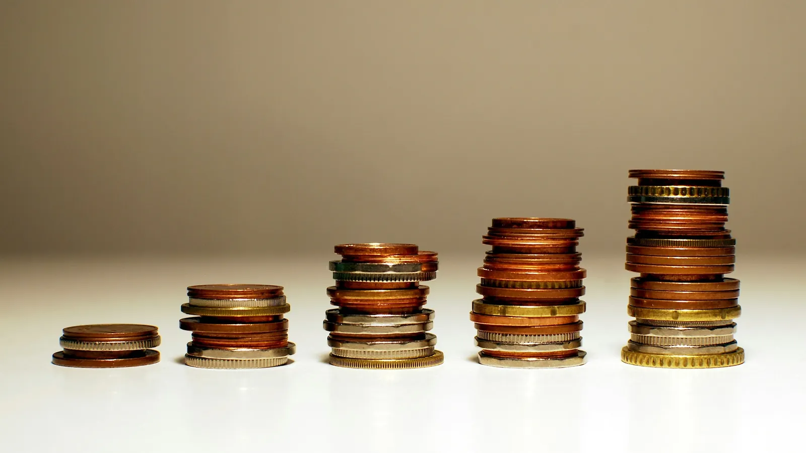 Stacks of coins growing taller from left to right