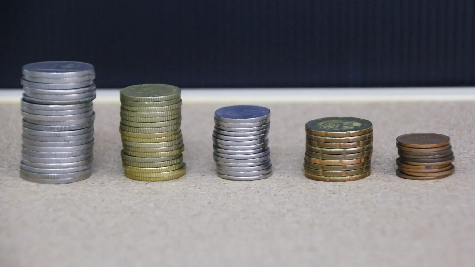 Stacks of coins of different heights arranged in a row