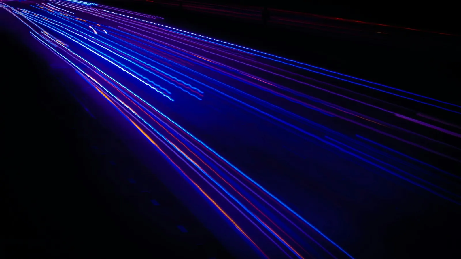 Streaks of blue light stretching across darkness