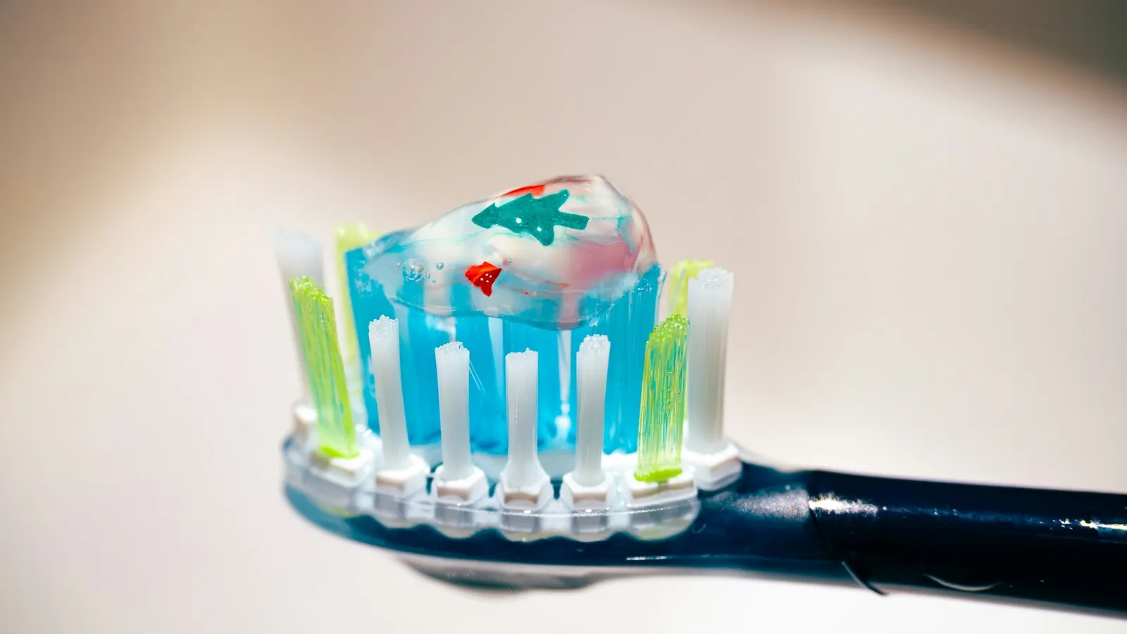 Striped toothpaste squeezed onto a toothbrush