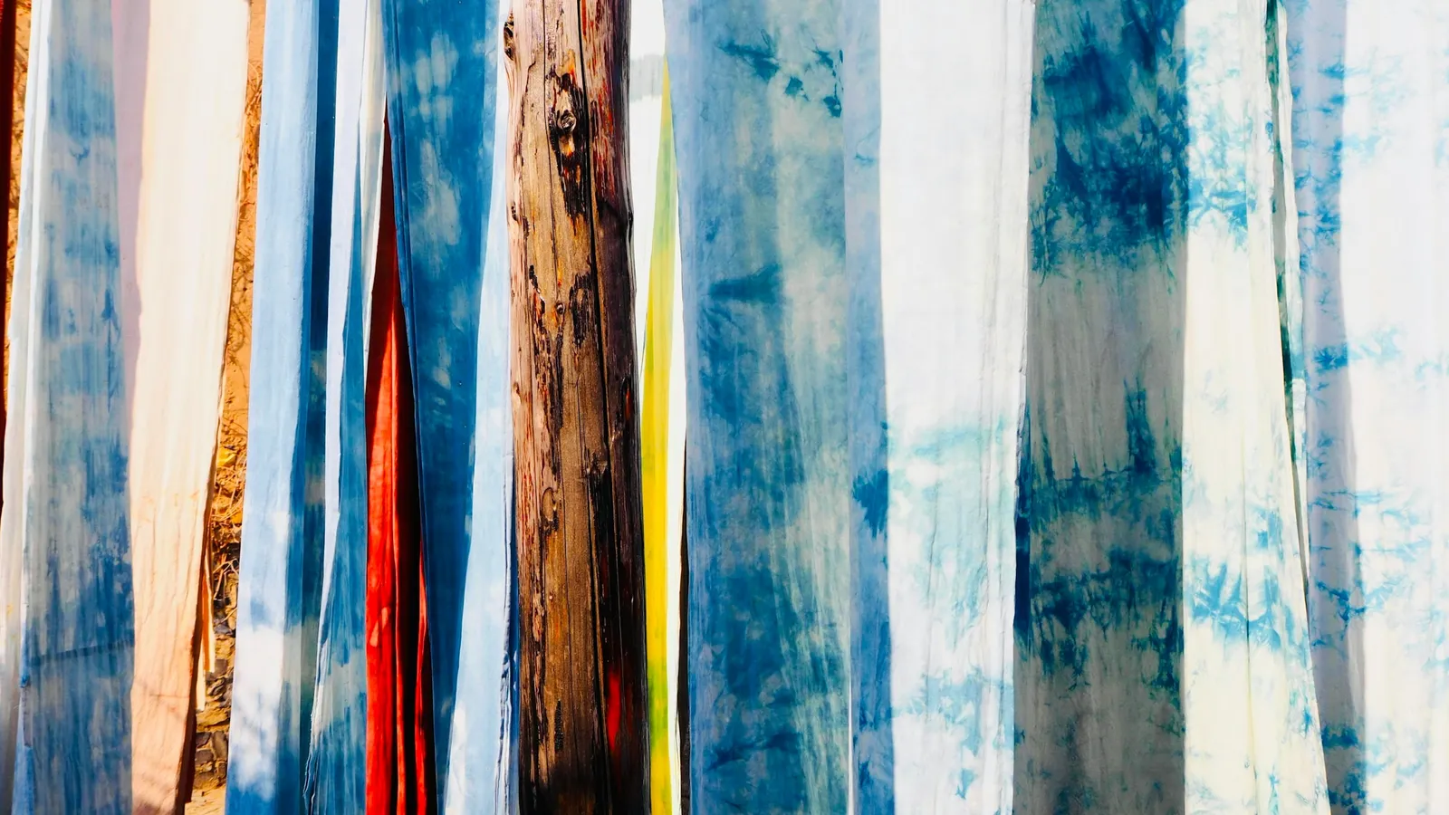 Strips of blue-dyed cloth hanging to dry