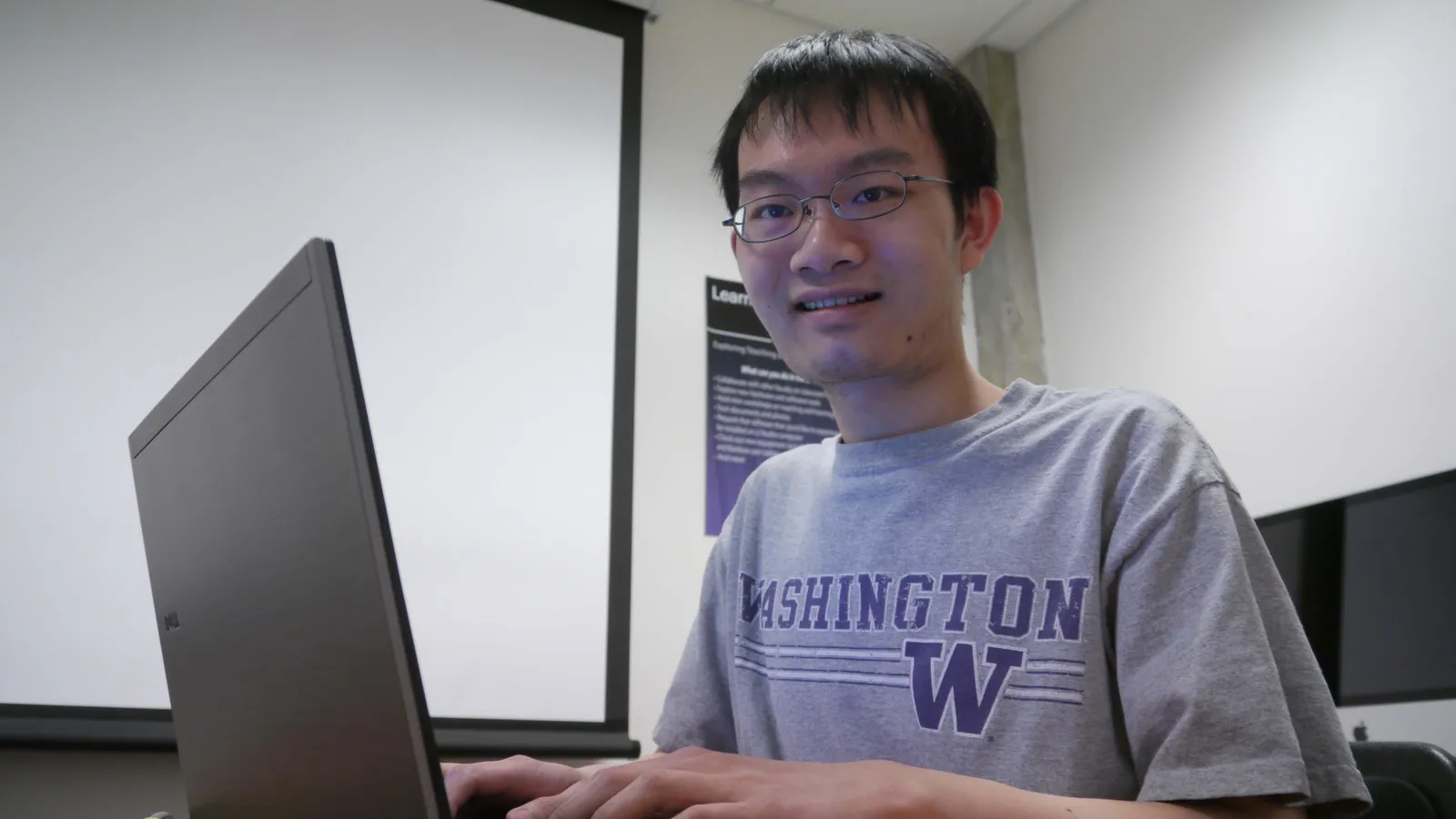 Student typing on a laptop computer