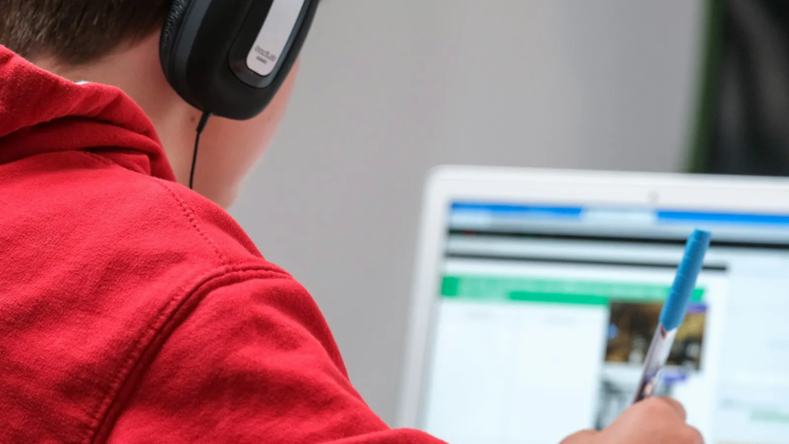 Student wearing headphones while working on a laptop