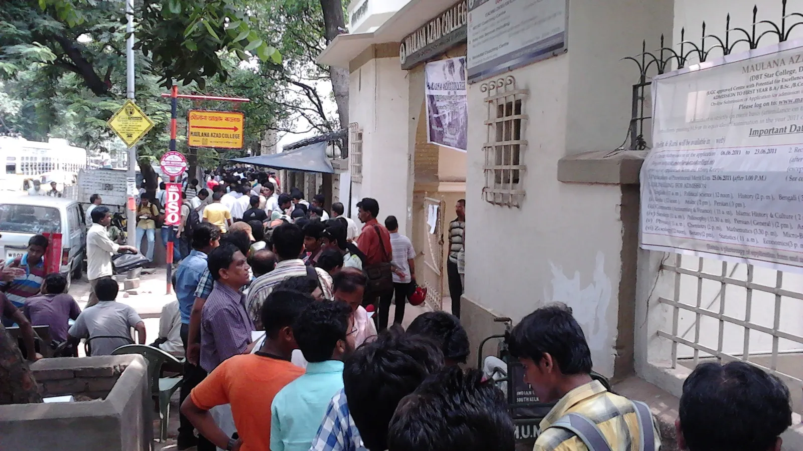 Students and guardians queue outside Maulana Azad College, Kolkata, beside its admission notice