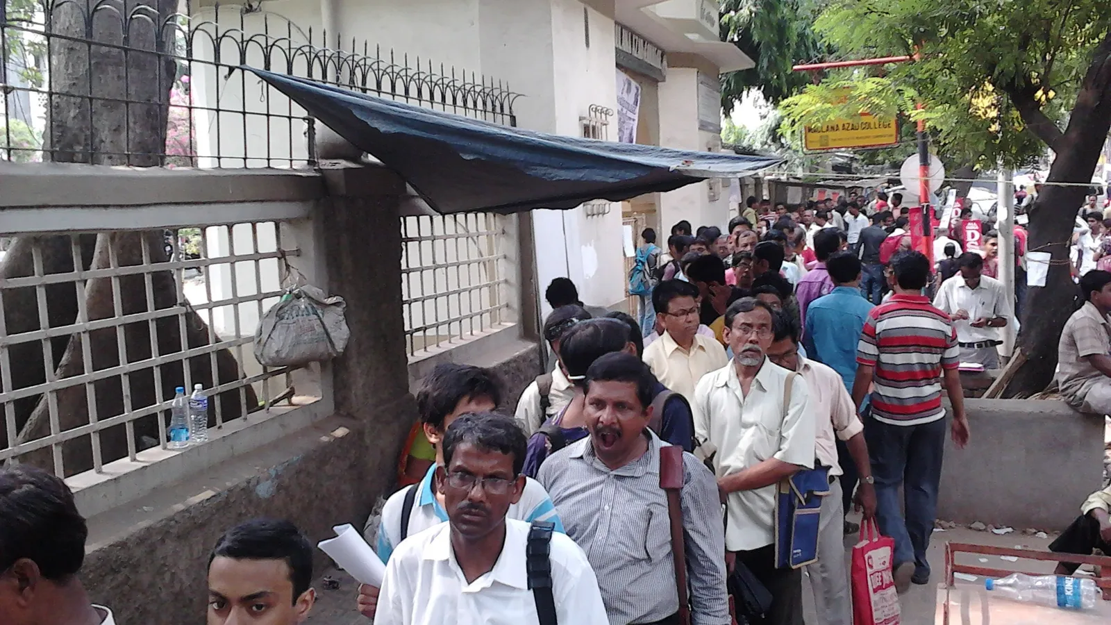Students and parents queue outside an admission office in Kolkata